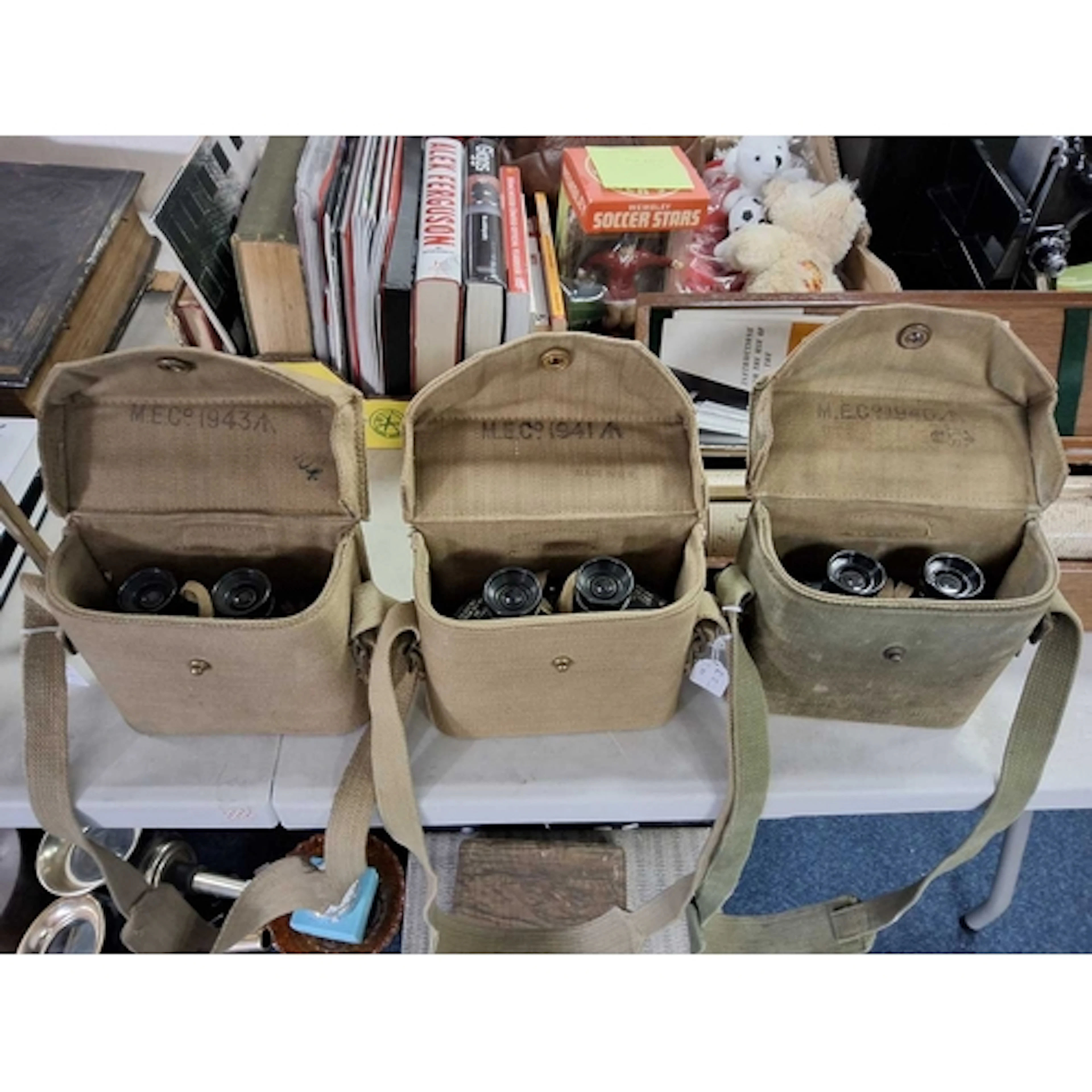 THREE SETS OF MILITARY BINOCULARS IN CANVAS CASES, set one i...
