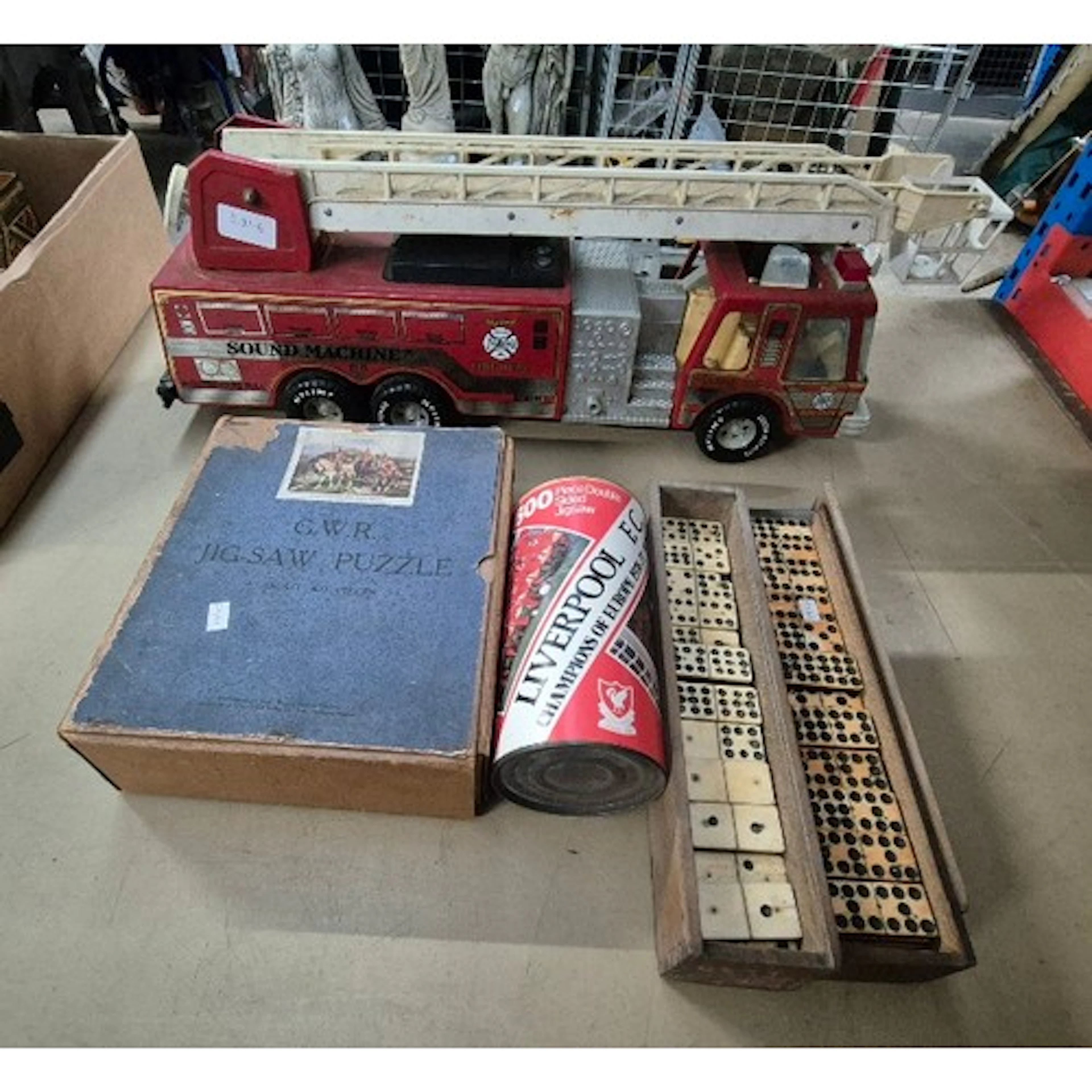 A group of vintage toys comprising of a tin Nylint fire engi...