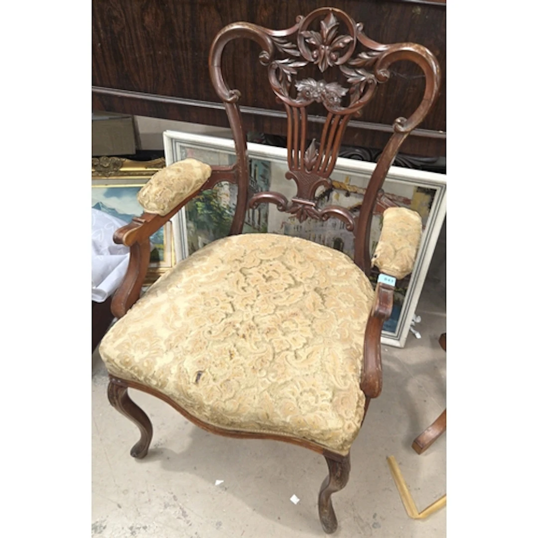 A late 19th century/early 20th century carved armchair with ...