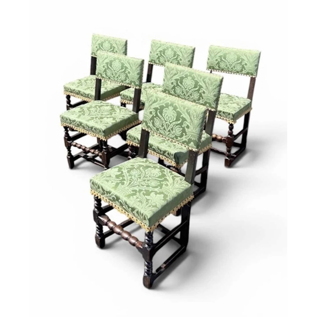 A HARLEQUIN SET OF SIX CHARLES II JOINED OAK AND UPHOLSTERED...