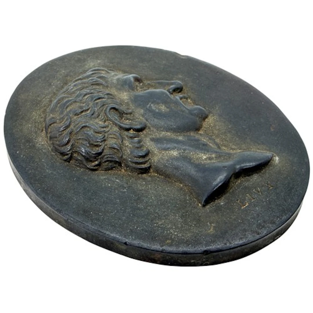 A Wedgwood black basalt plaque of oval form, moulded in reli...