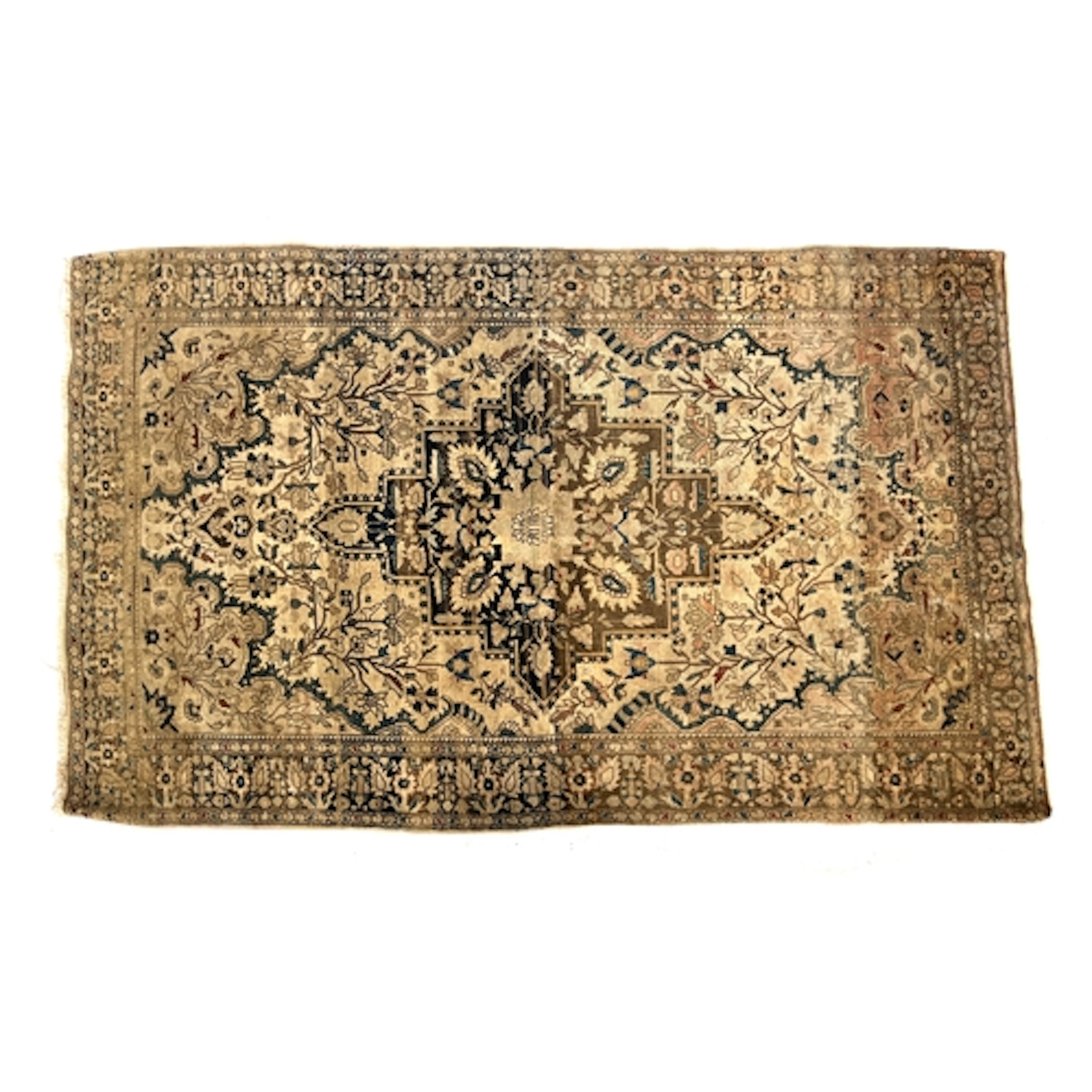 A well worn cream ground Persian rug with central medallion,...