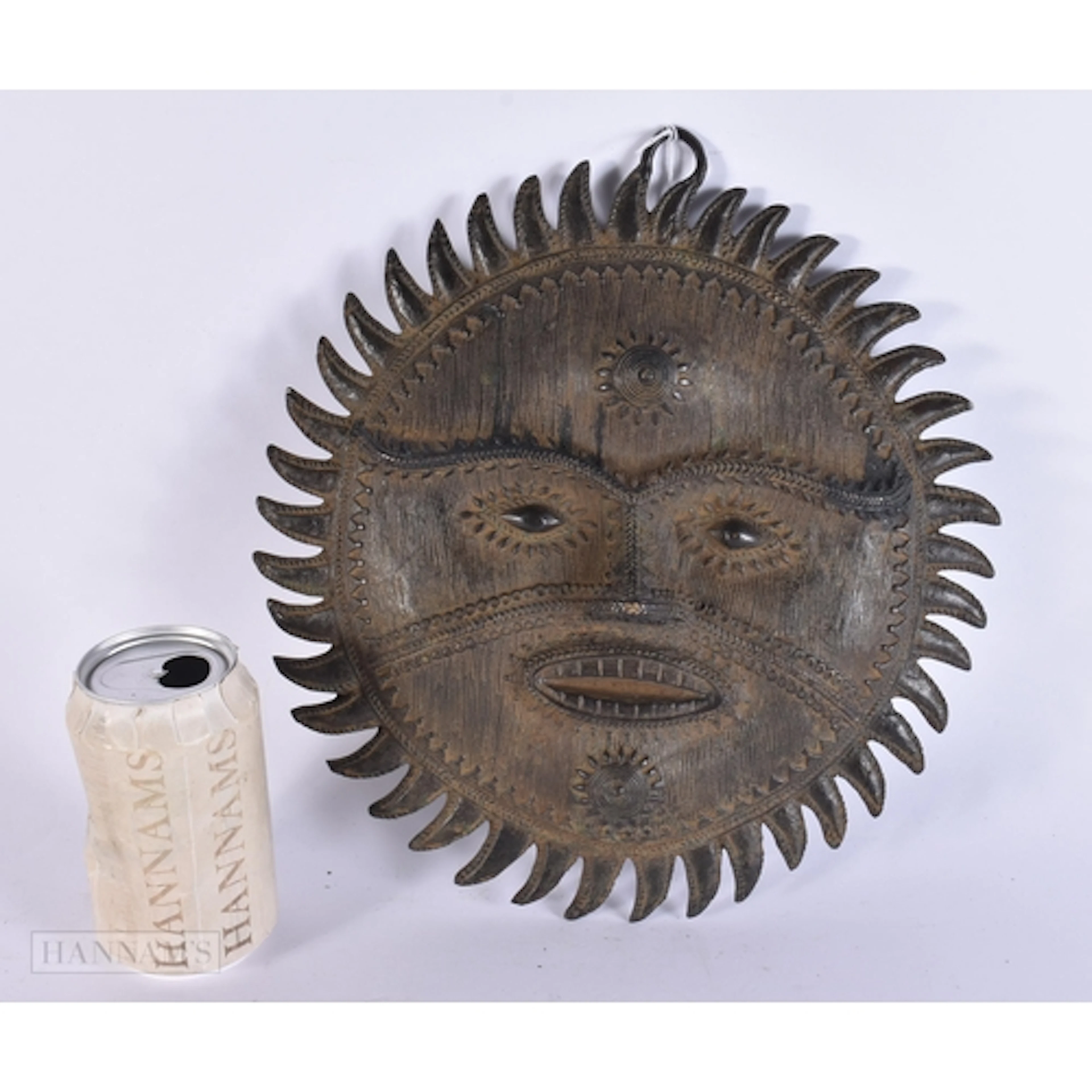AN ANTIQUE TRIBAL BRONZE SUNBURST MASK. 25.5 cm wide.