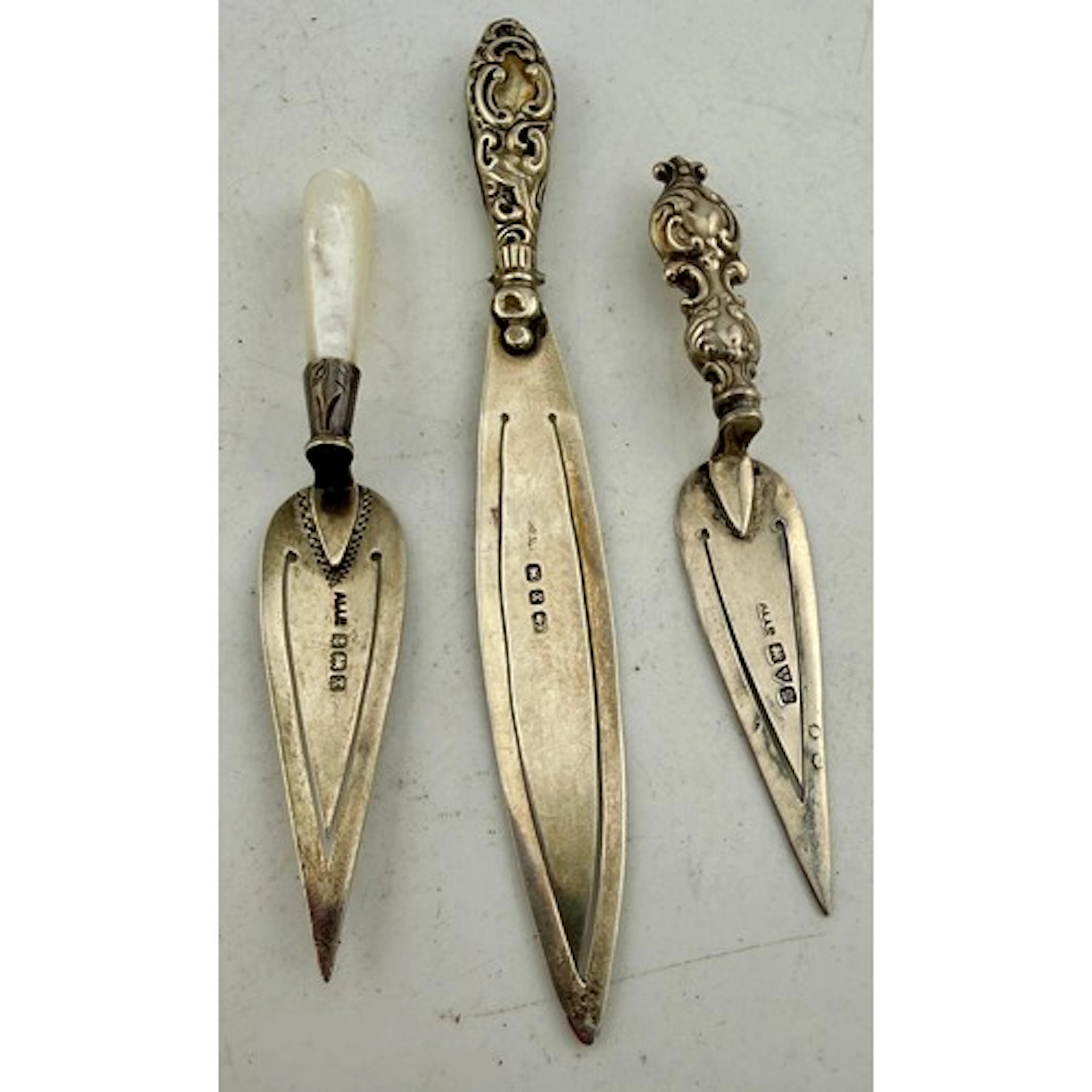 Three hallmarked silver bookmarks to include one with mother...