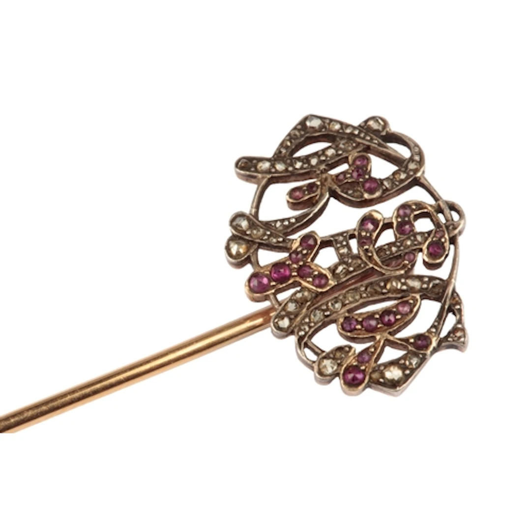 A garnet and diamond stick pin, late 19th/early 20th century...
