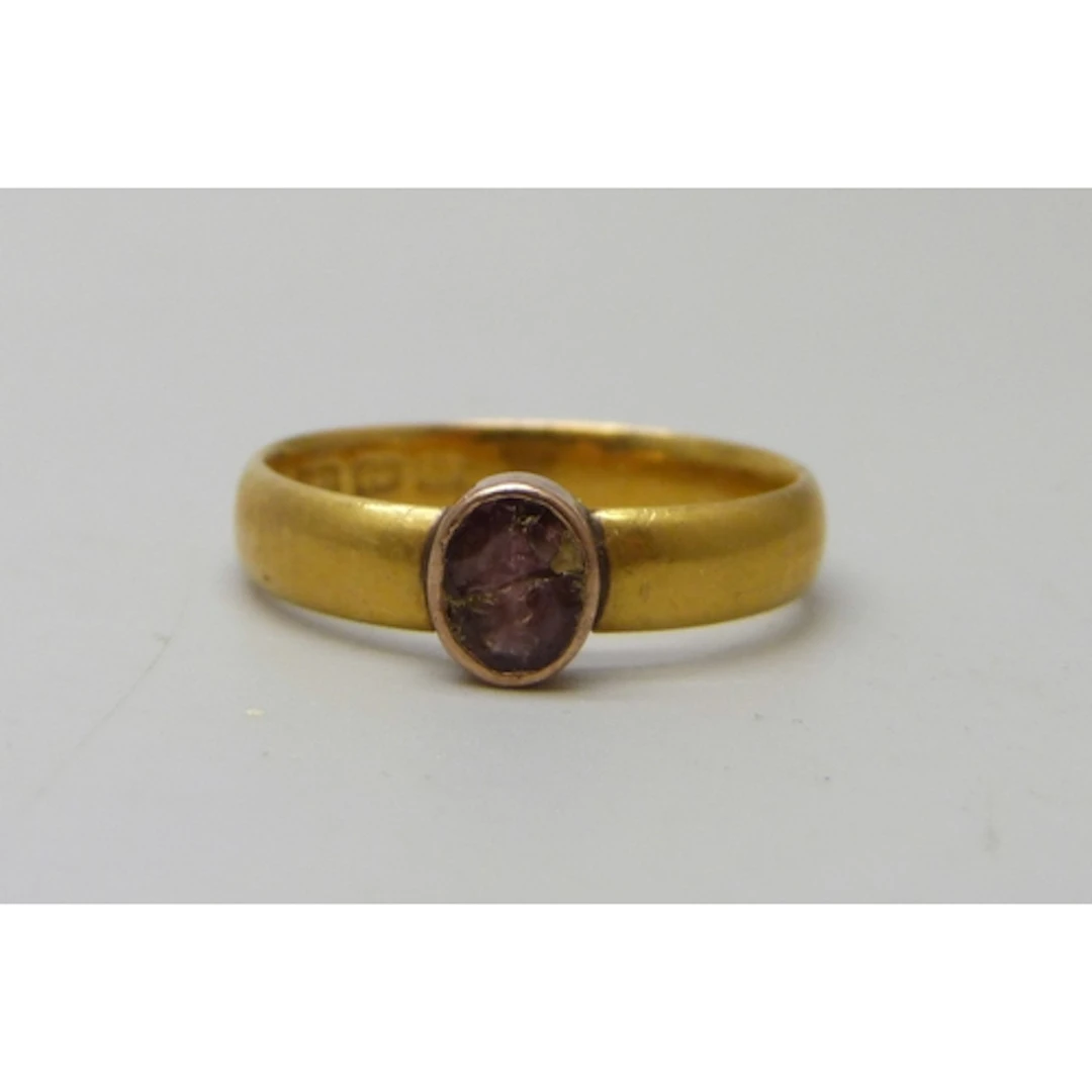 A 22ct gold wedding band ring, with later added lower carat ...