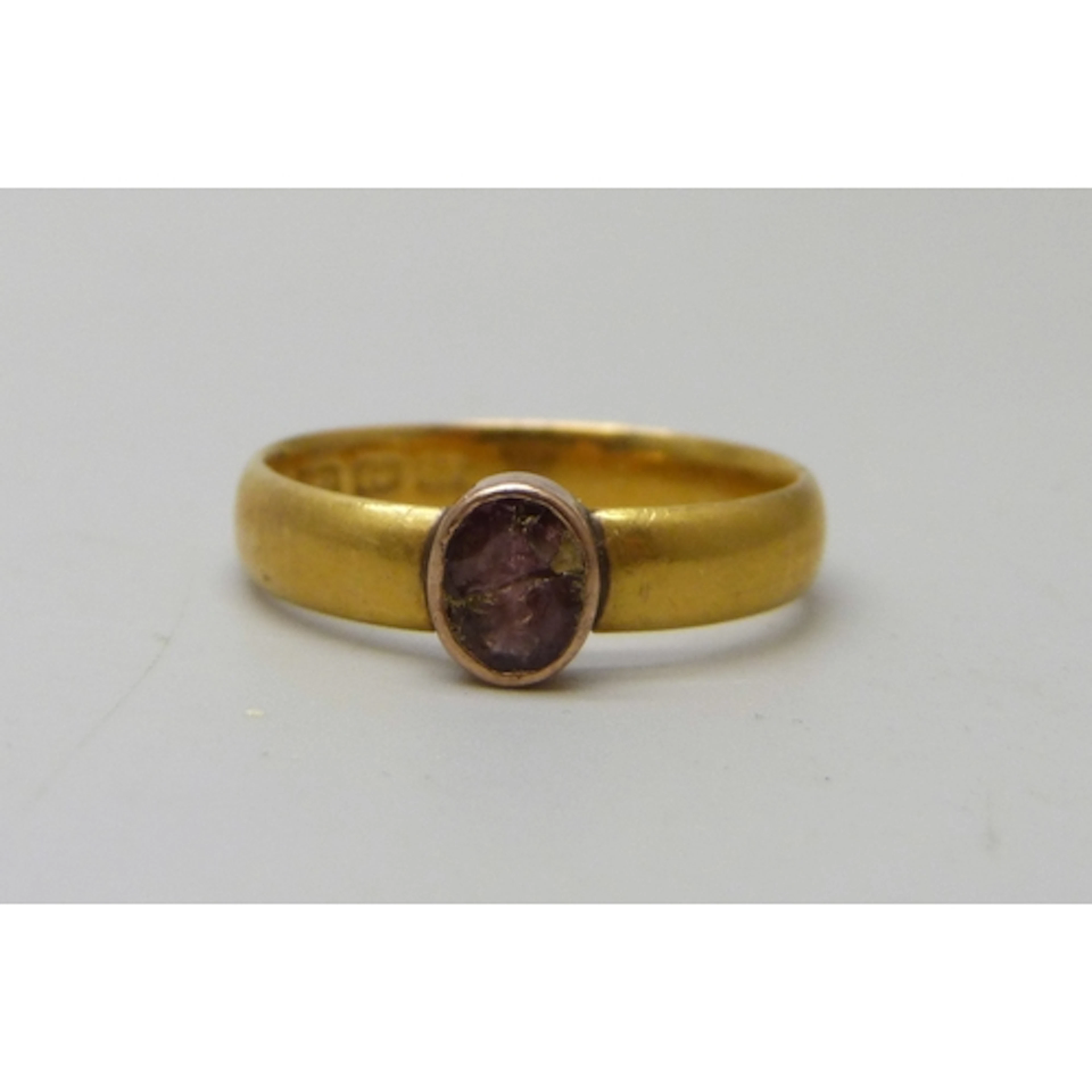A 22ct gold wedding band ring, with later added lower carat ...
