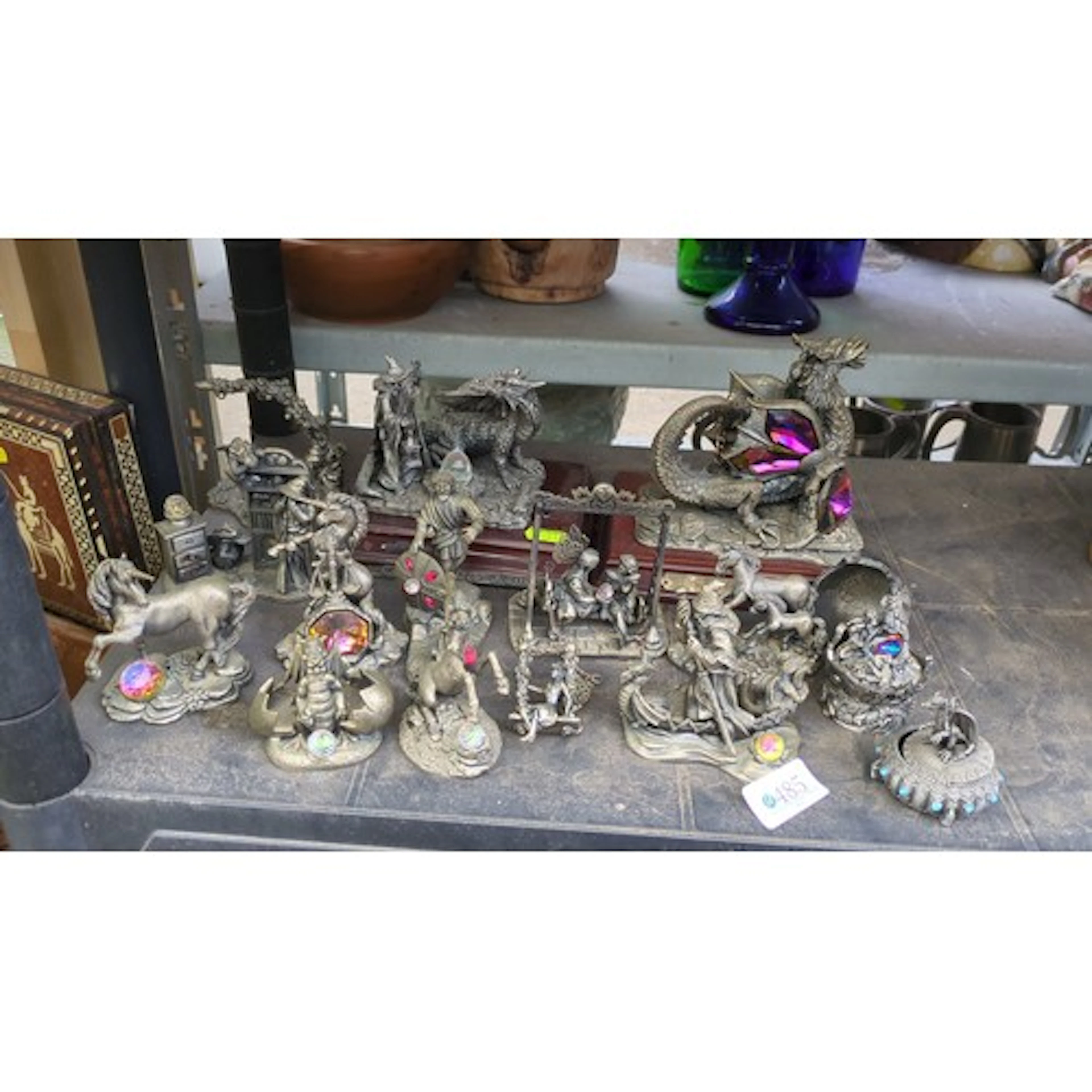 A group of modern cast metal fantasy figurines and small obj...