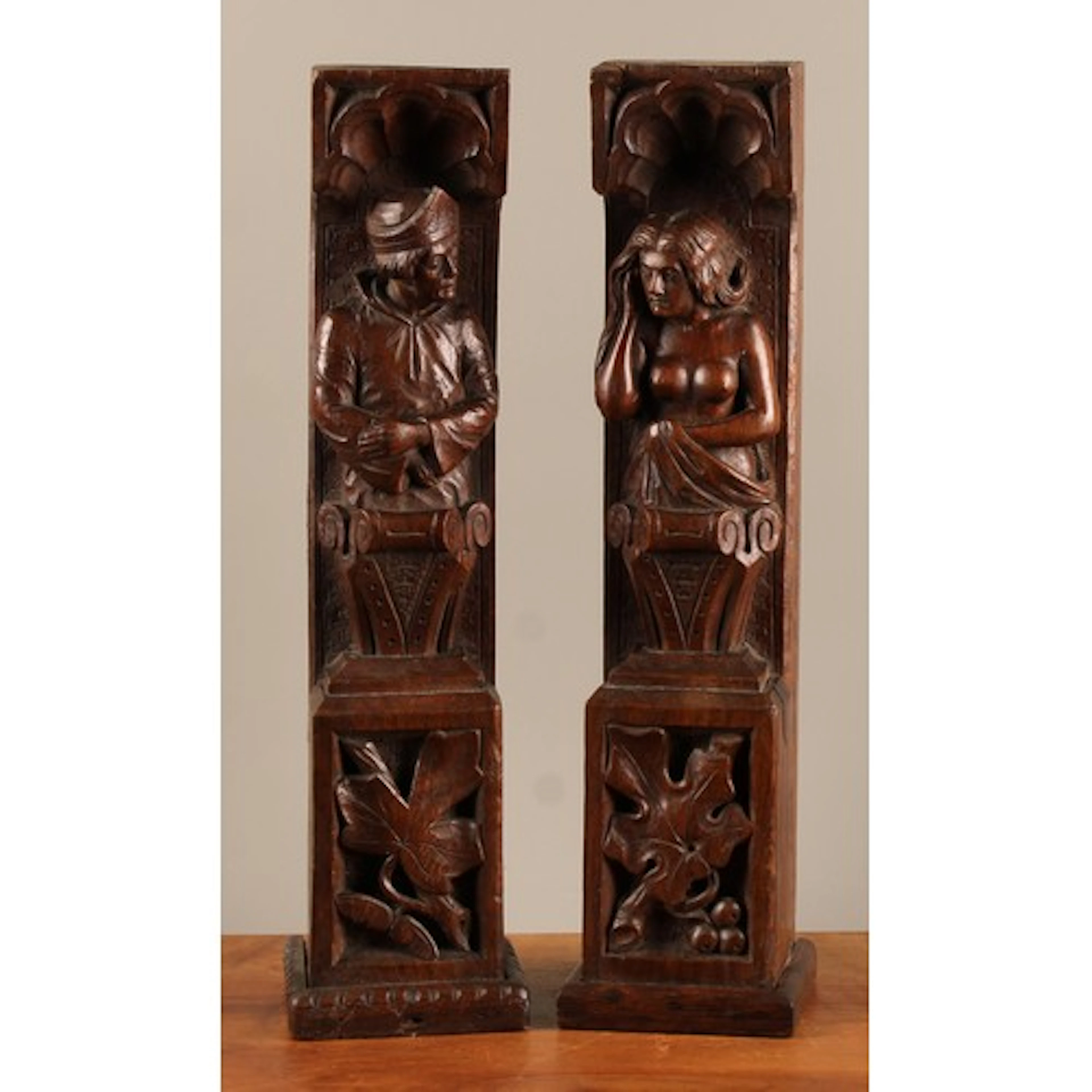 A pair of North European oak figural pilasters, carved as ma...