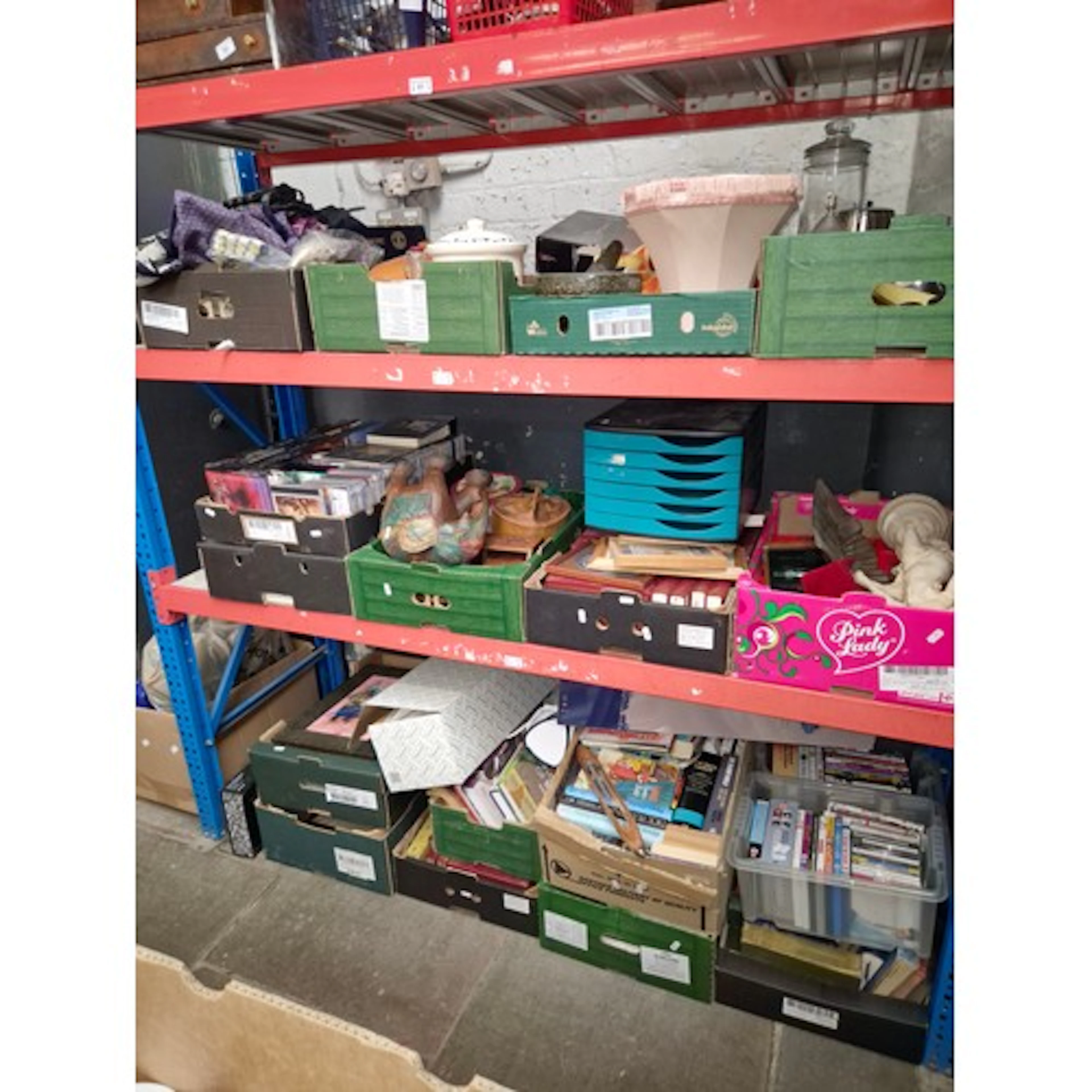 3 shelves of mixed items in 18 boxes containing books, DVDs,...