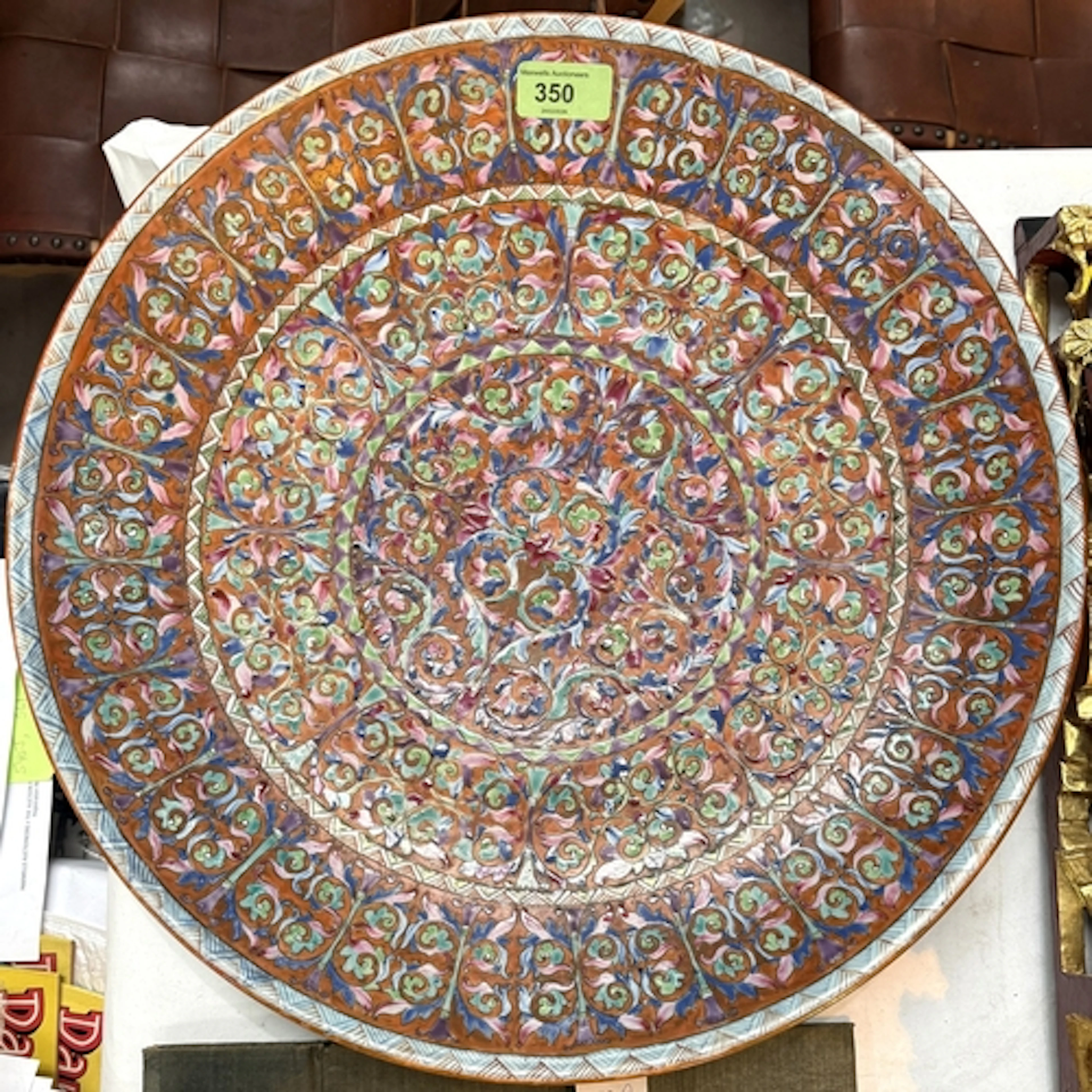 A large 19th century Chinese dish, famille rose with red gro...