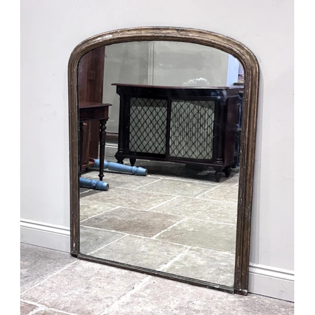 A Victorian gilt painted overmantel mirror, the arched singl...