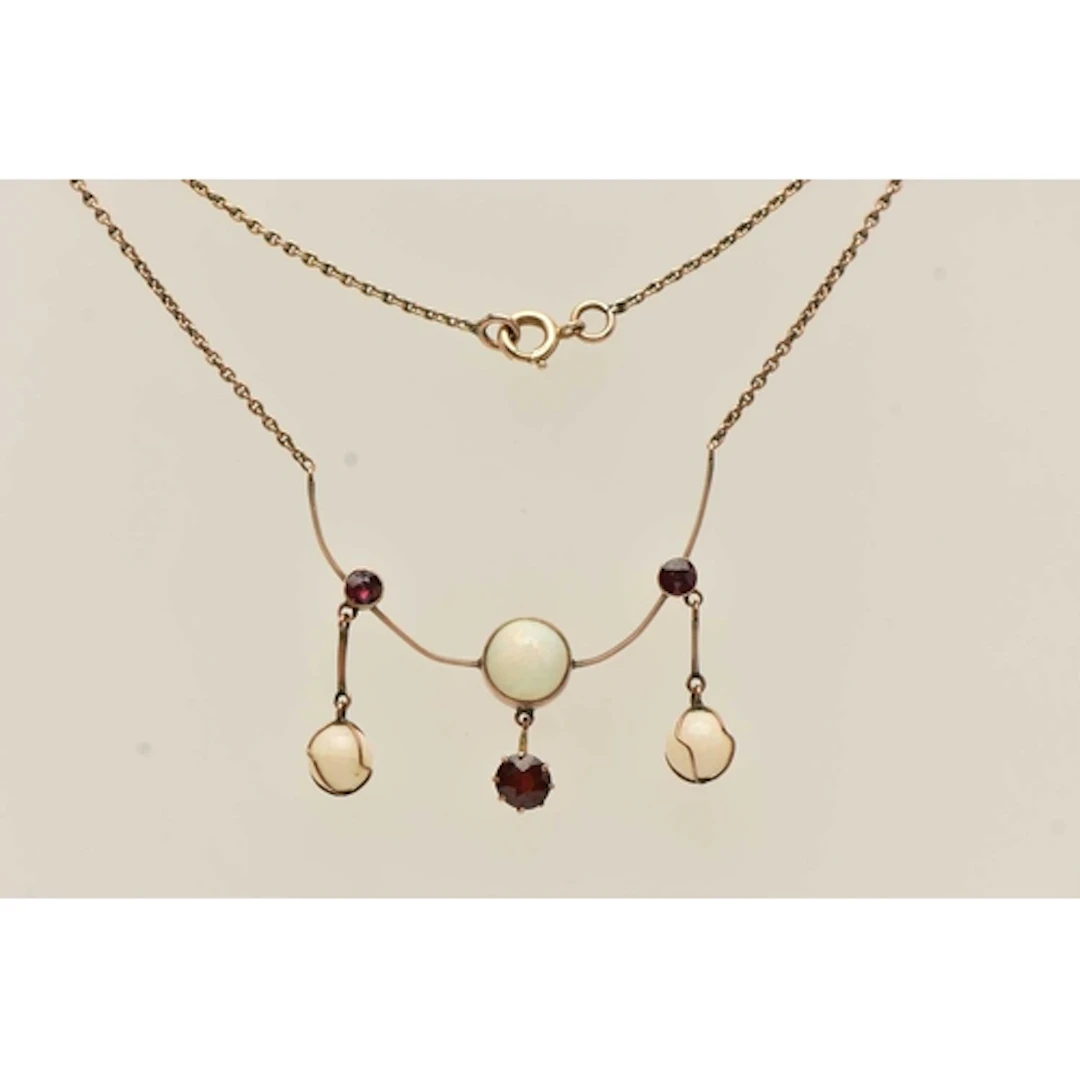 A YELLOW METAL OPAL AND GARNET PENDANT NECKLACE, the pendant...