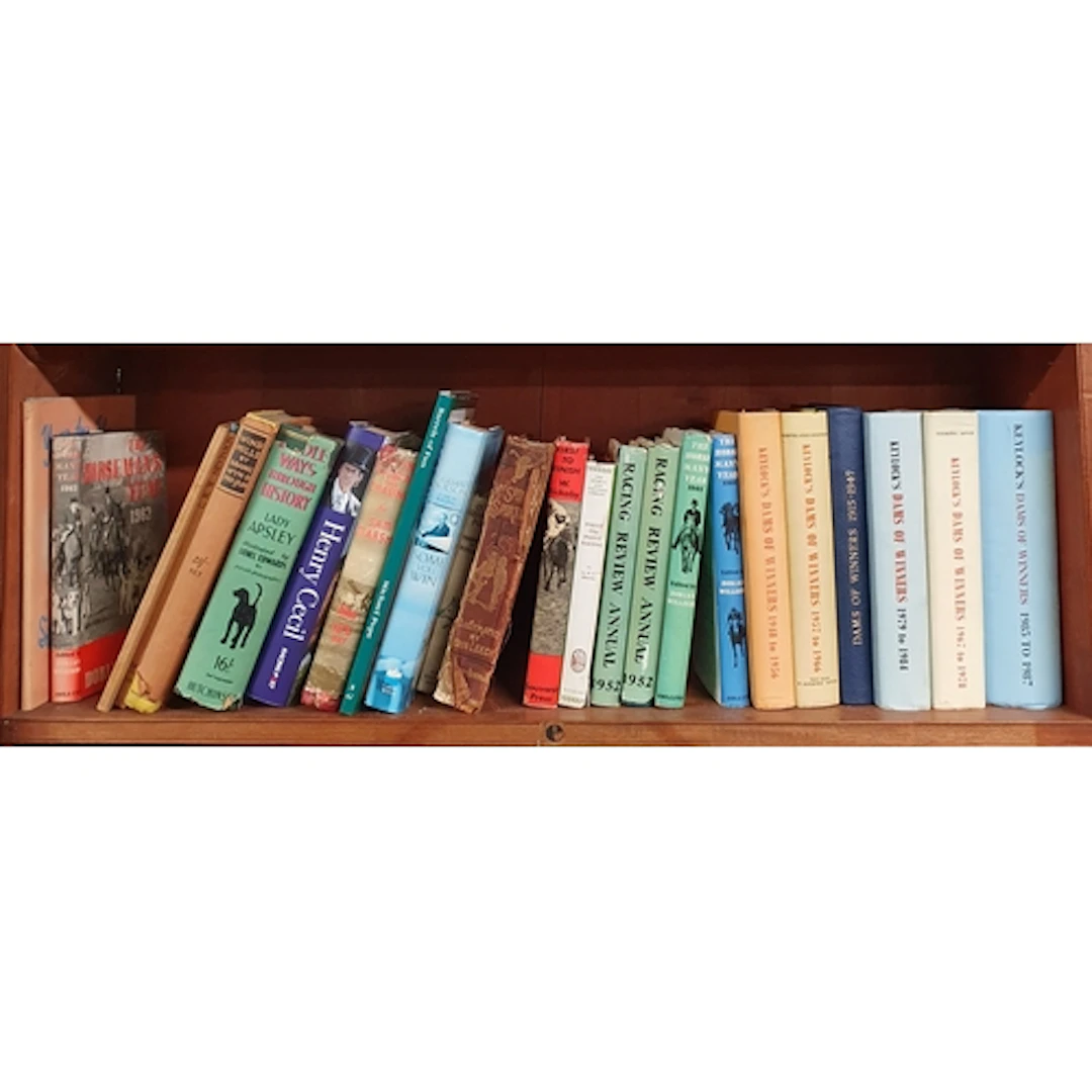 A quantity of Racing and Stud Books on one shelf.