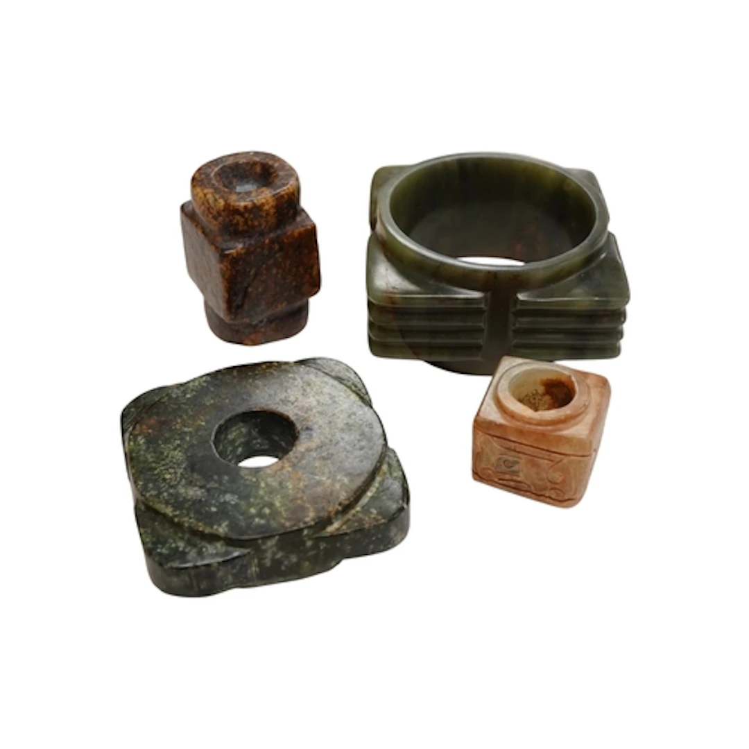 Four Chinese archaistic carved jade or hardstone congs, larg...