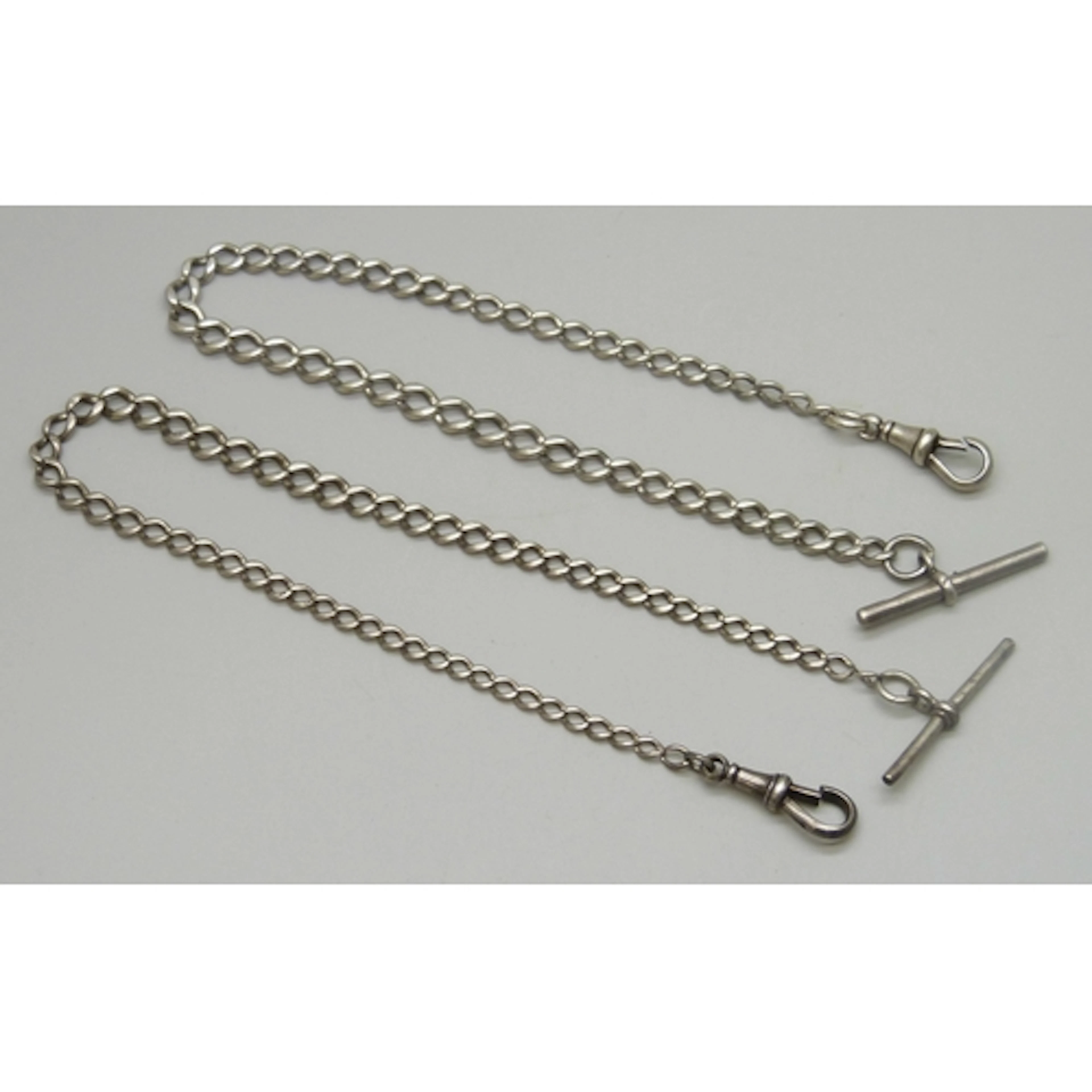 Two white metal Albert chains, both with silver dog clips an...
