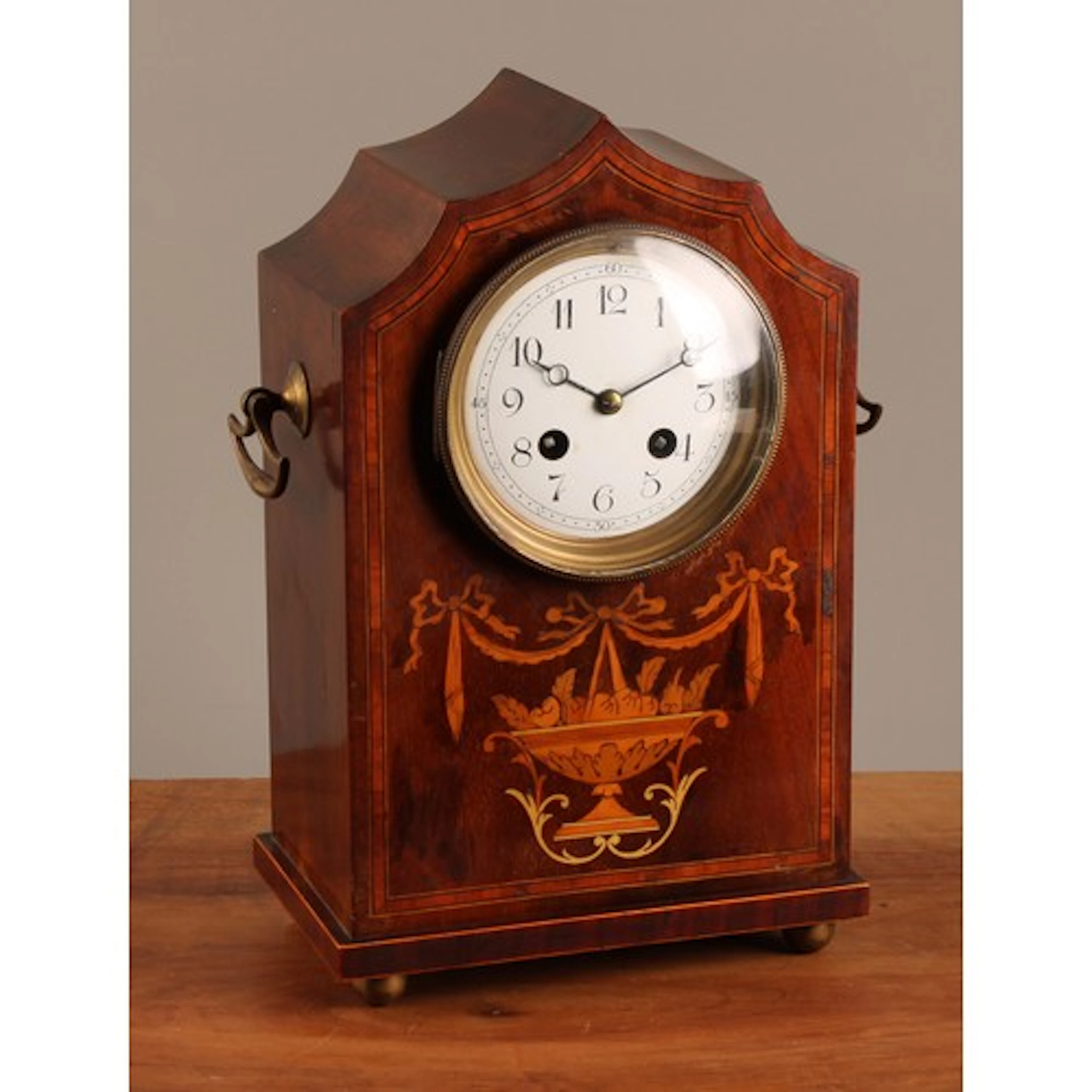 An Edwardian mahogany inlaid lancet clock, inverted arched t...