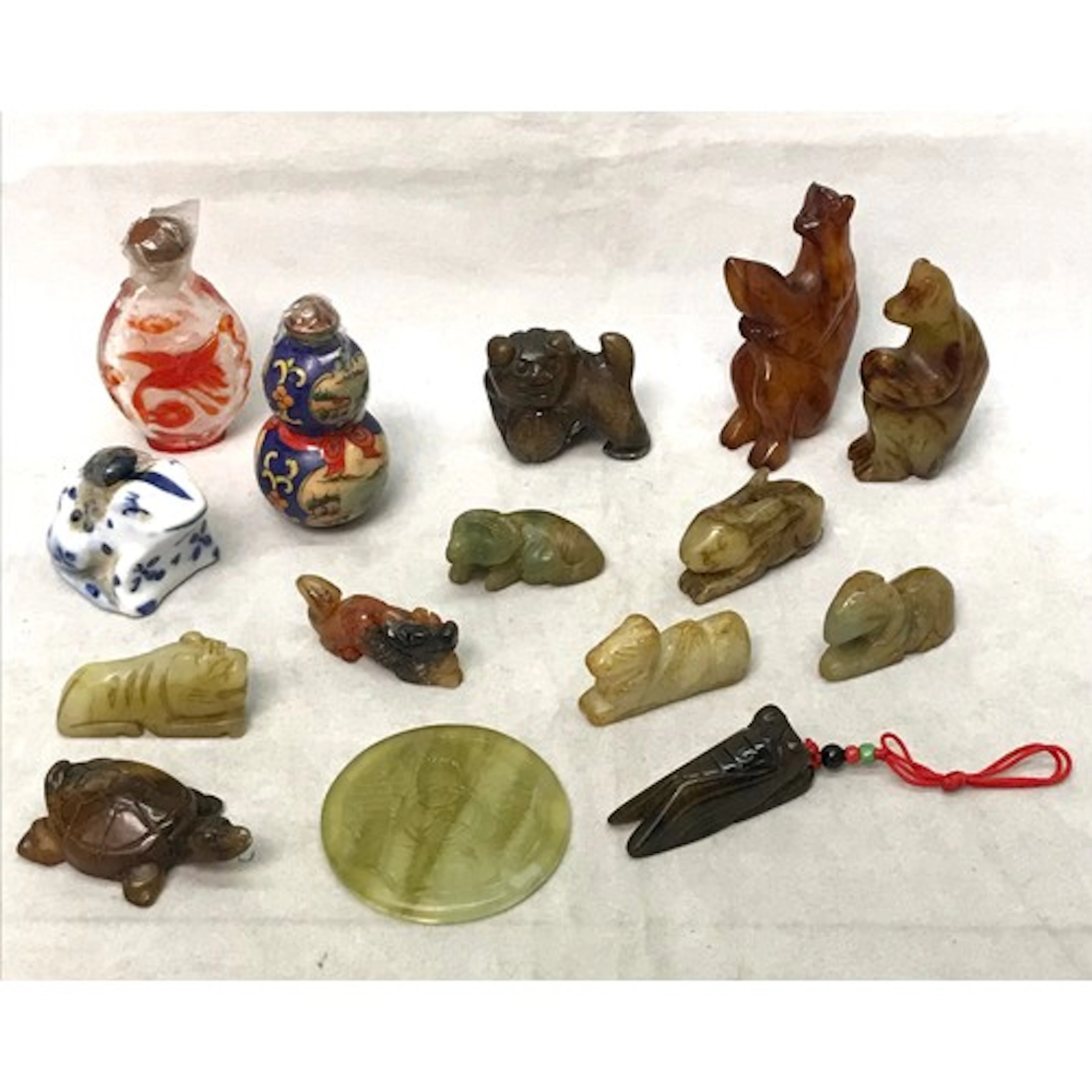 A collection of oriental carved hardstone animal figurines a...