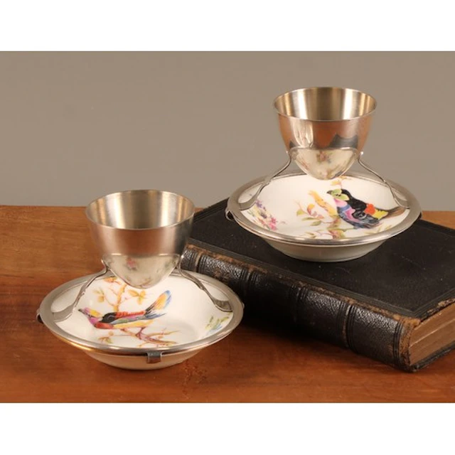 A pair of early 20th century silver plate and porcelain egg ...