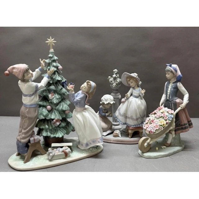 Three large Lladro figural scenes to include children trimmi...