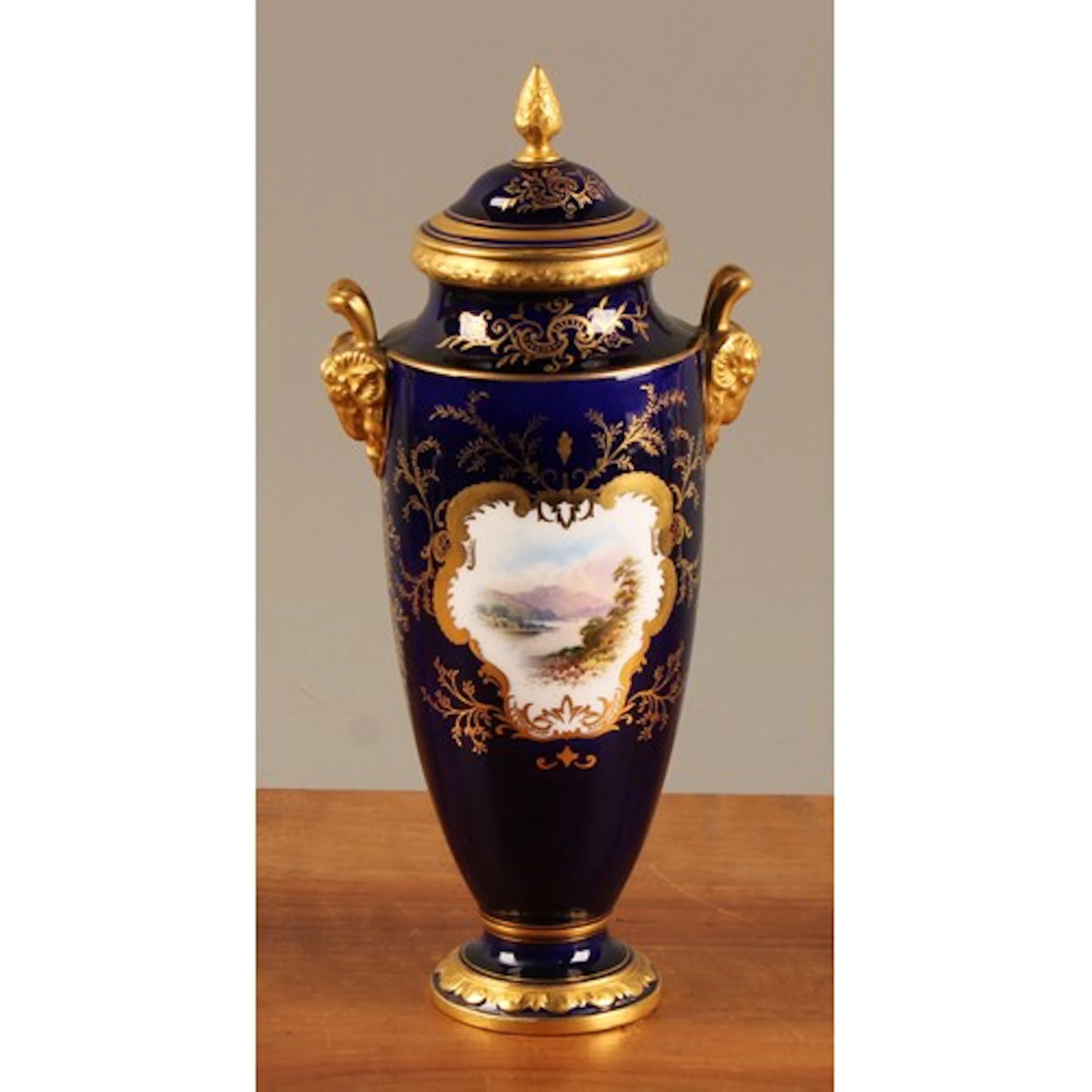 A Coalport two handled pedestal ovoid vase and cover, of sle...
