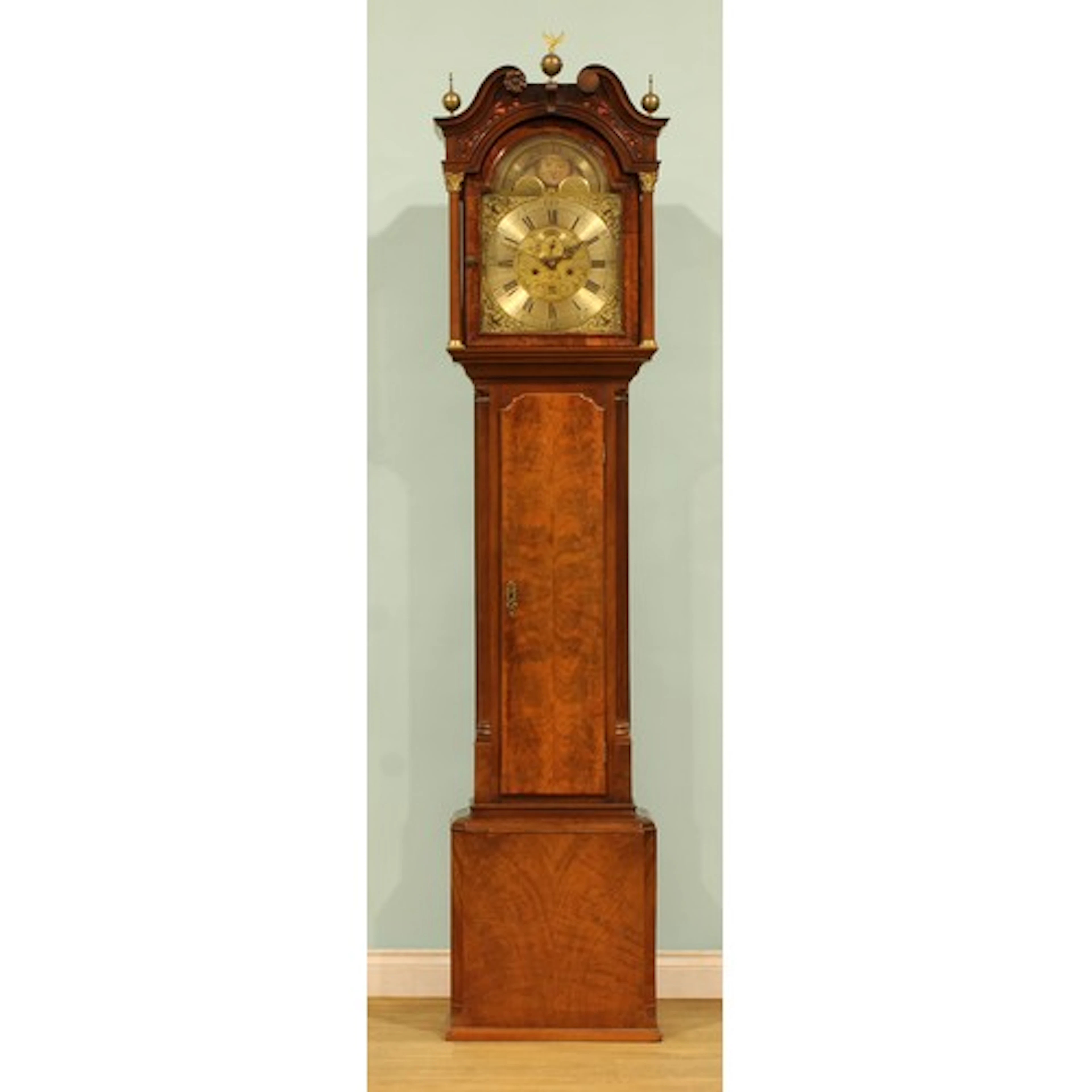 A George III mahogany longcase clock, 34cm arched brass dial...