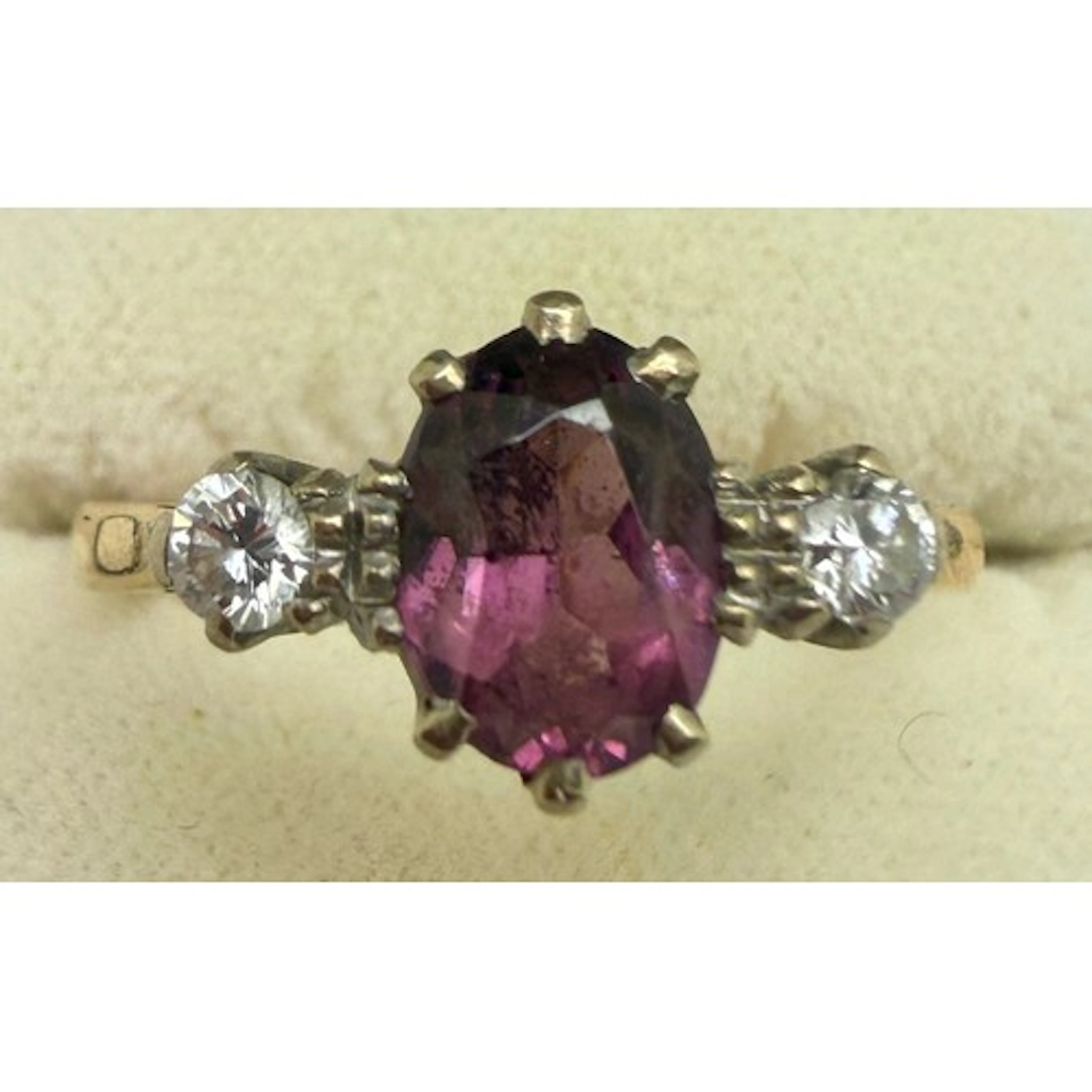 An 18 carat yellow gold ring set with two diamonds and centr...