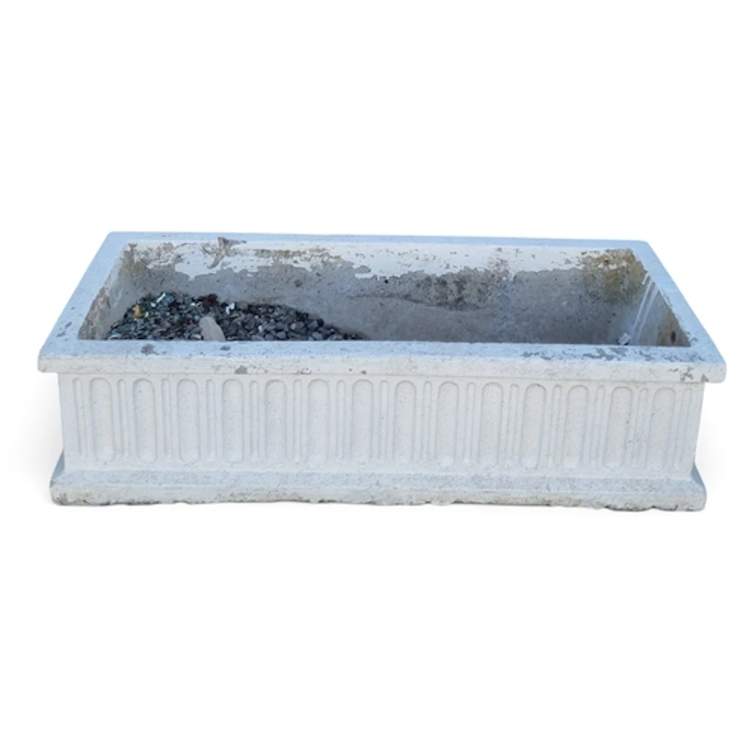 A long and narrow reconstituted Stone Planter with a fluted ...