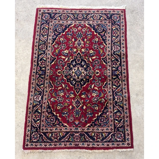 A Persian Kashan wool rug, hand knotted, with a central meda...