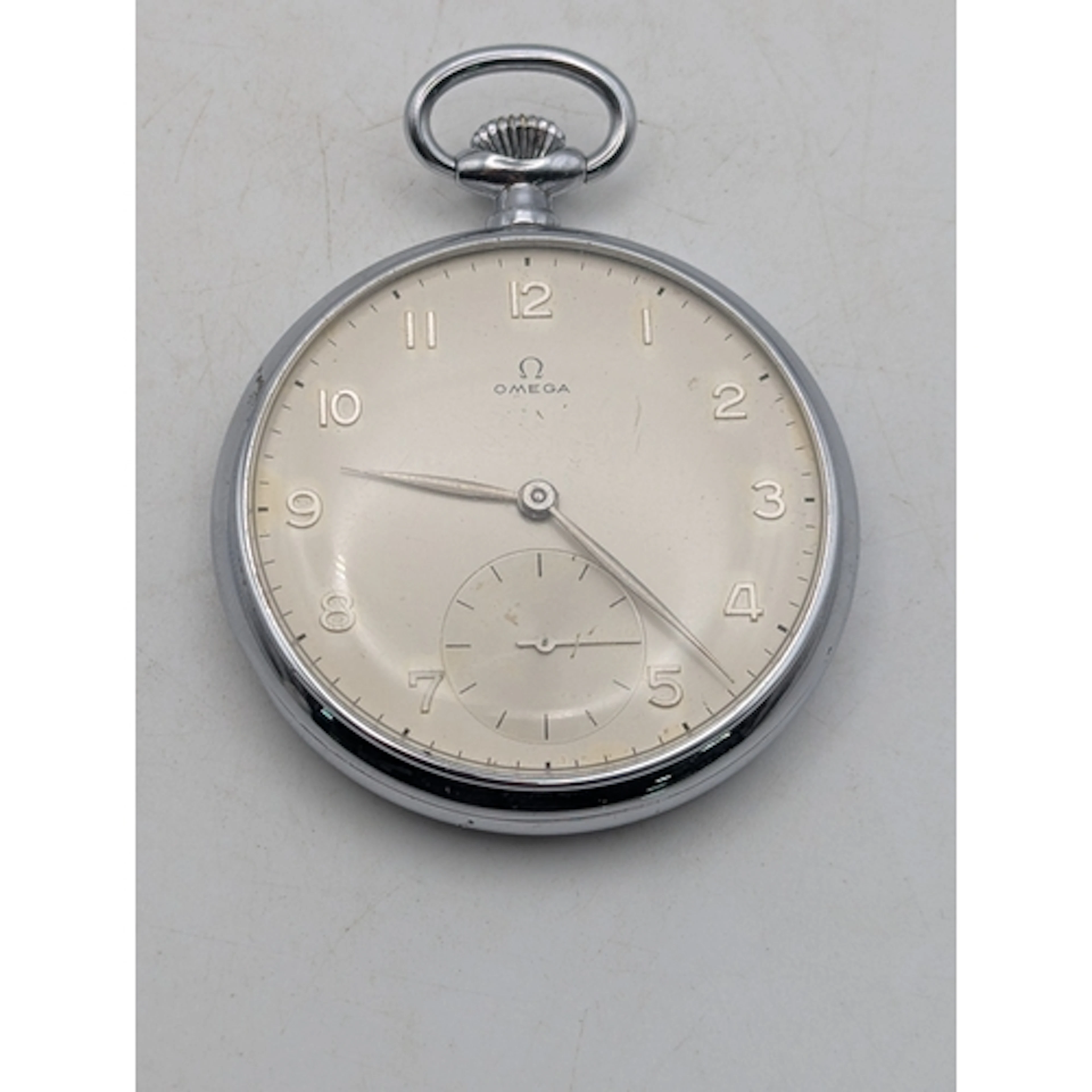 A vintage Omega pocket watch, nickel chrome case, open faced...