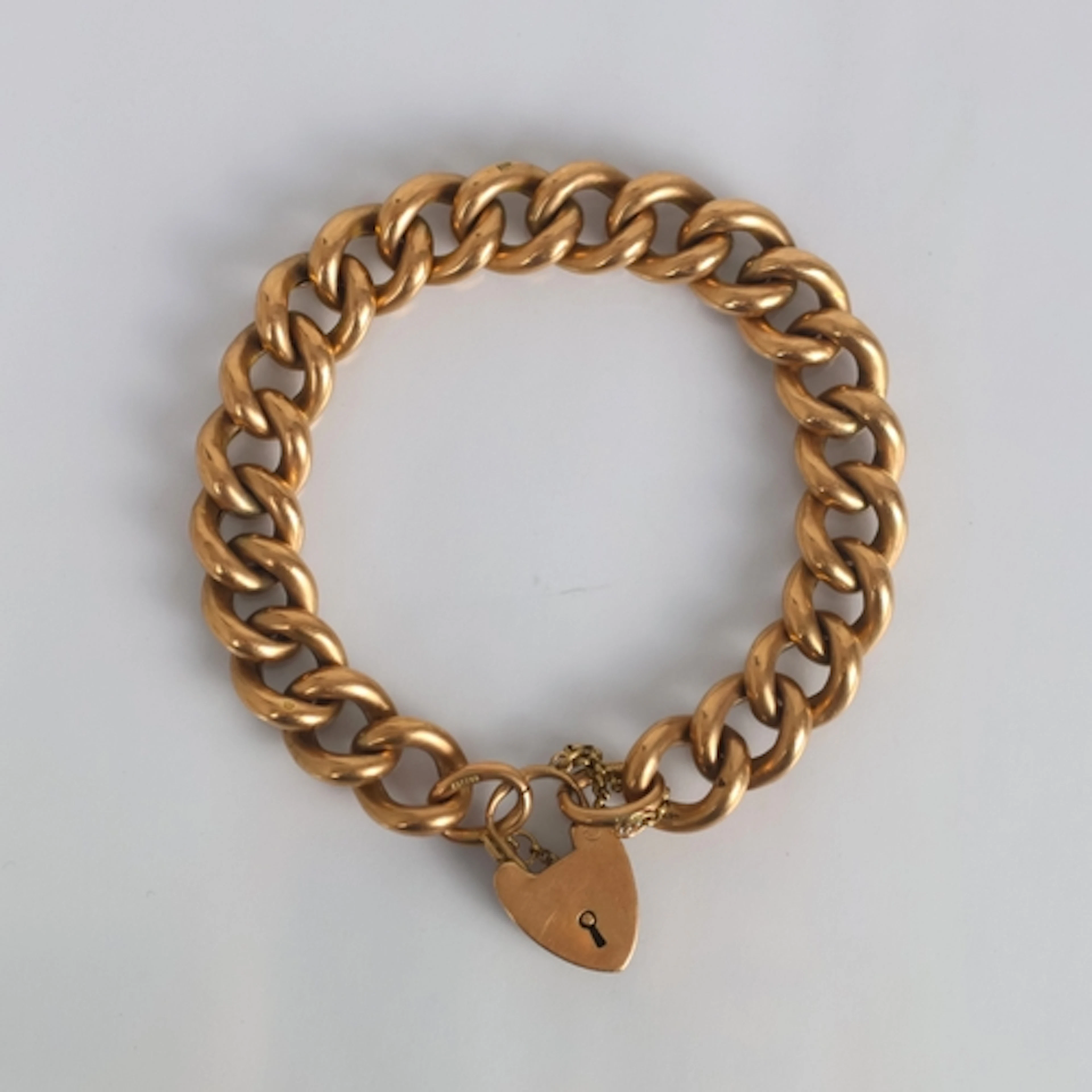 An early 20th century yellow metal bracelet, the hollow curb...