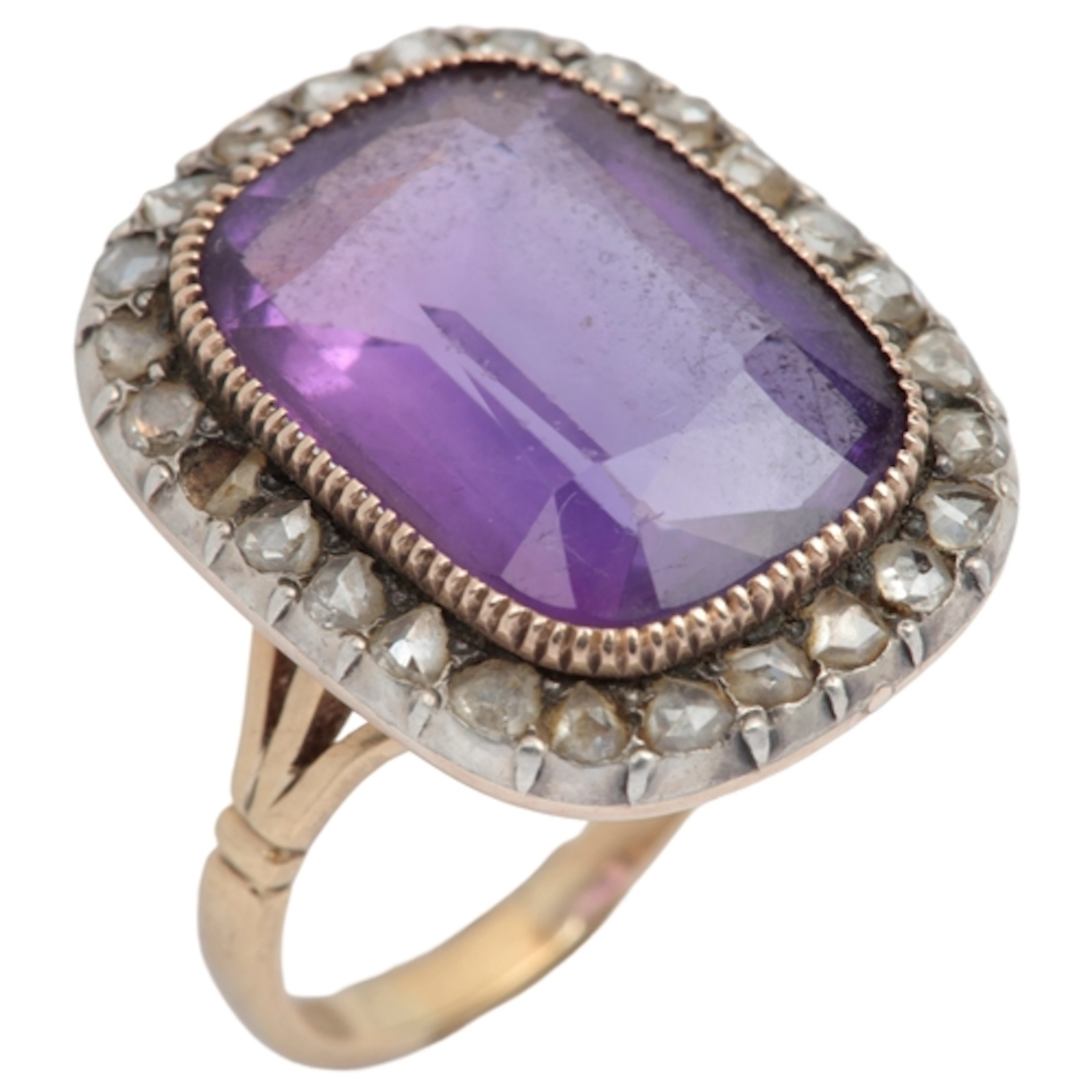 An amethyst and diamond ring, set with an elongated cushion-...