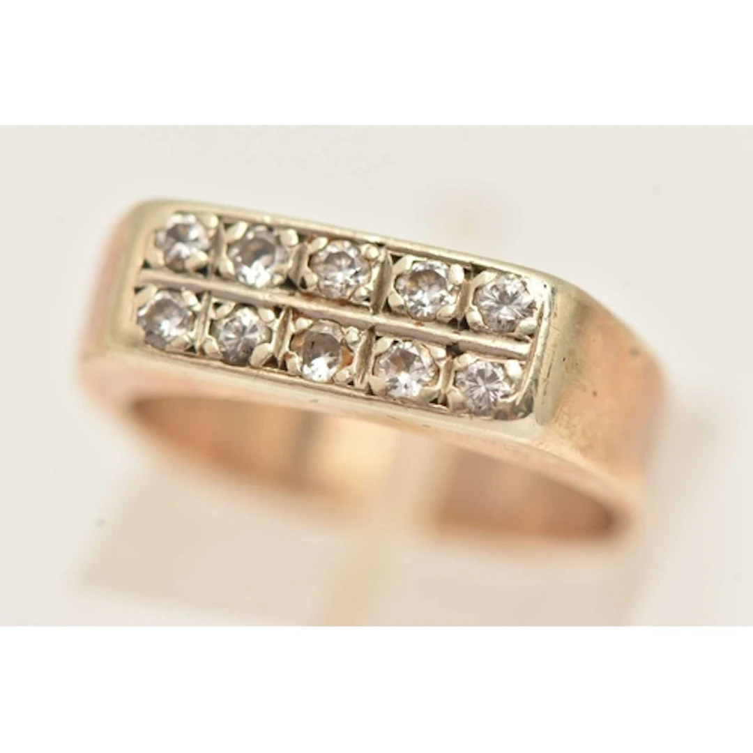 A YELLOW METAL DIAMOND RING, set with two rows of small roun...