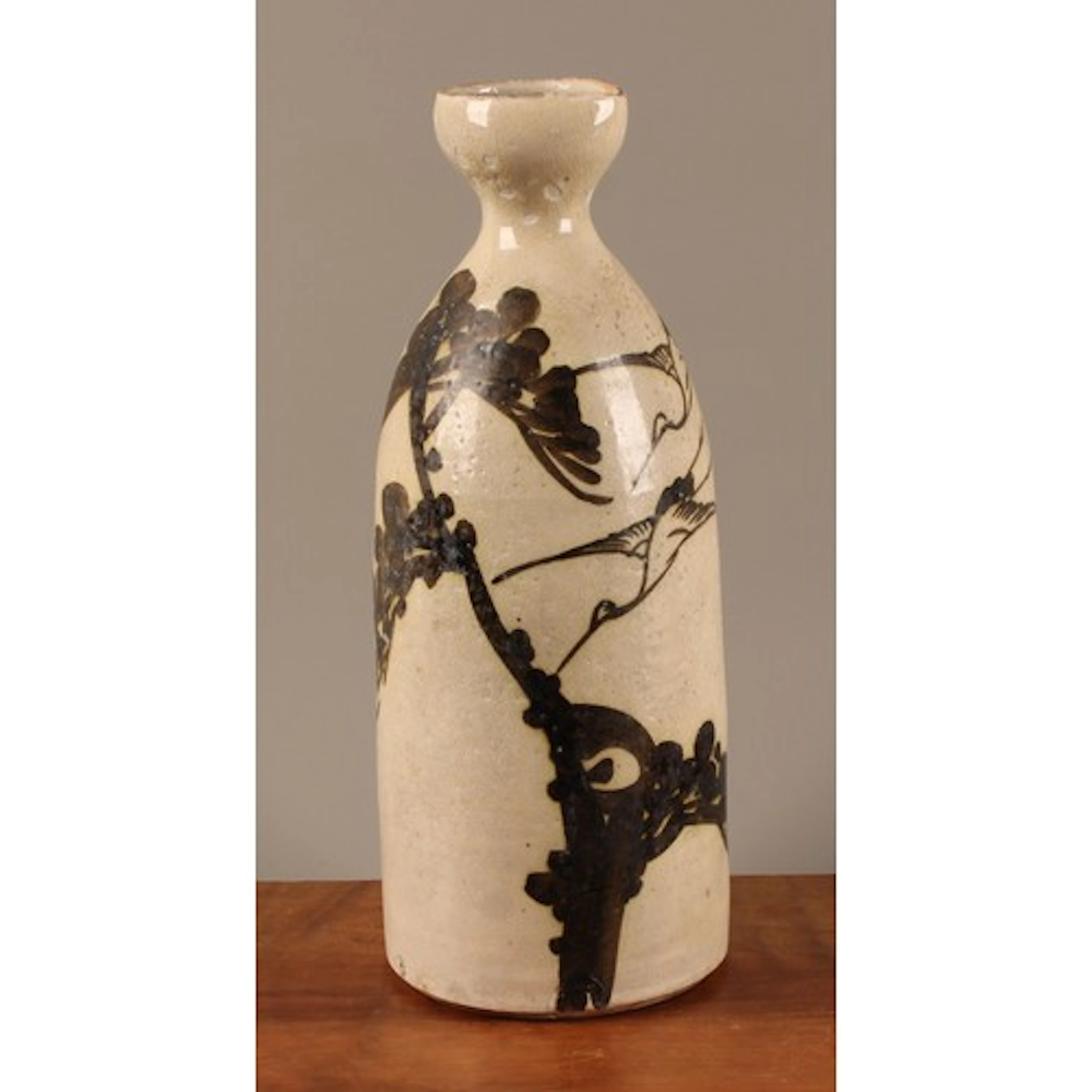 A Japanese tokkuri or sake bottle, decorated with cranes and...