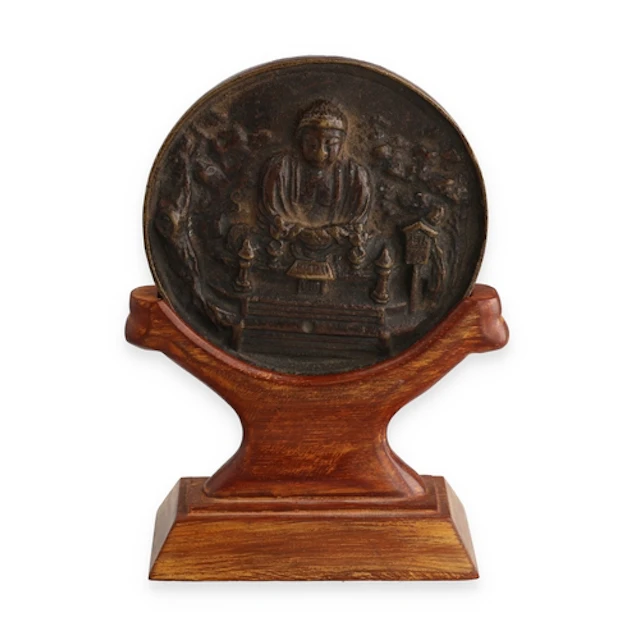 A JAPANESE BRONZE BUDDHA COIN On wooden stand. 10 cm W...