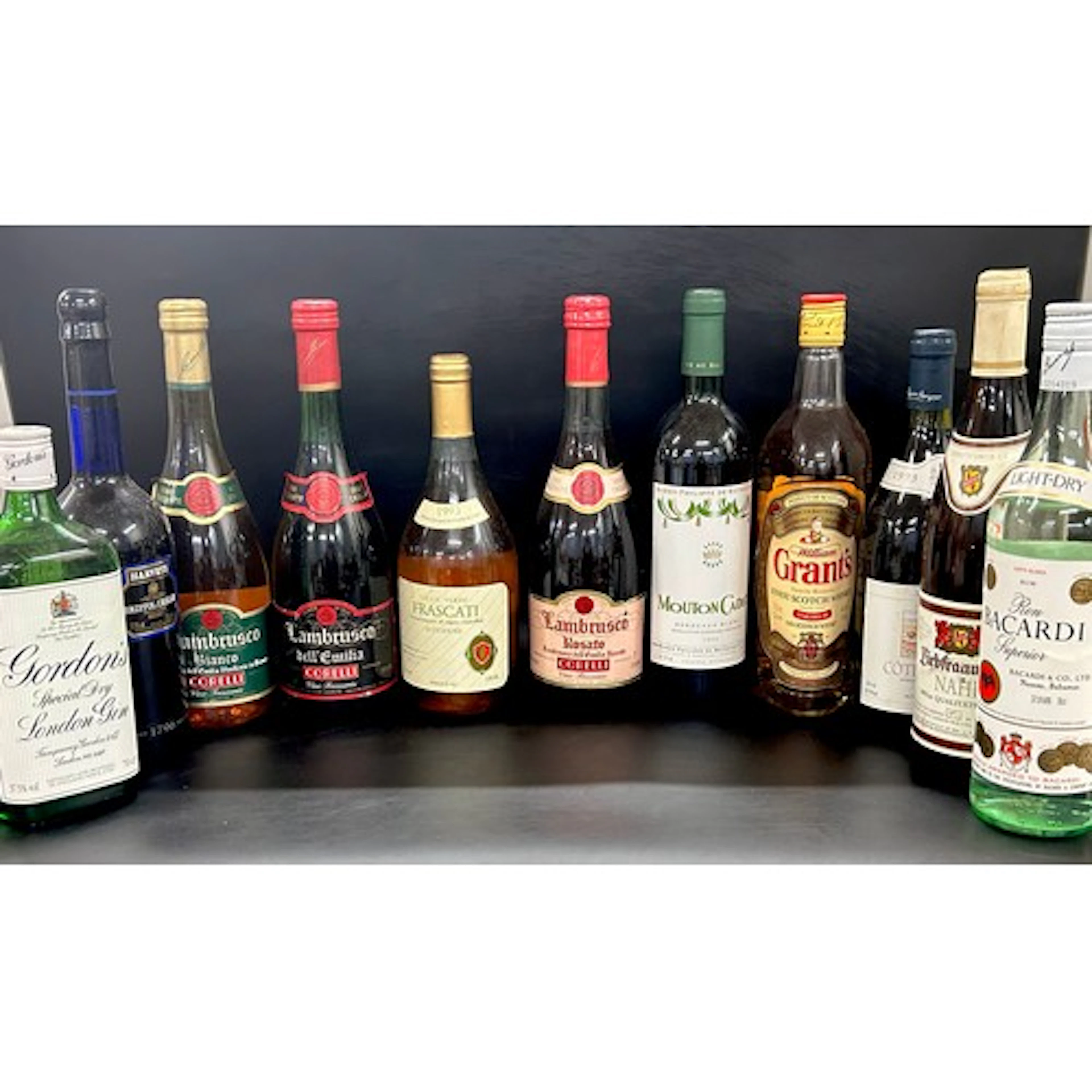 A box of vintage alcohol bottles including Grant's whisky em...