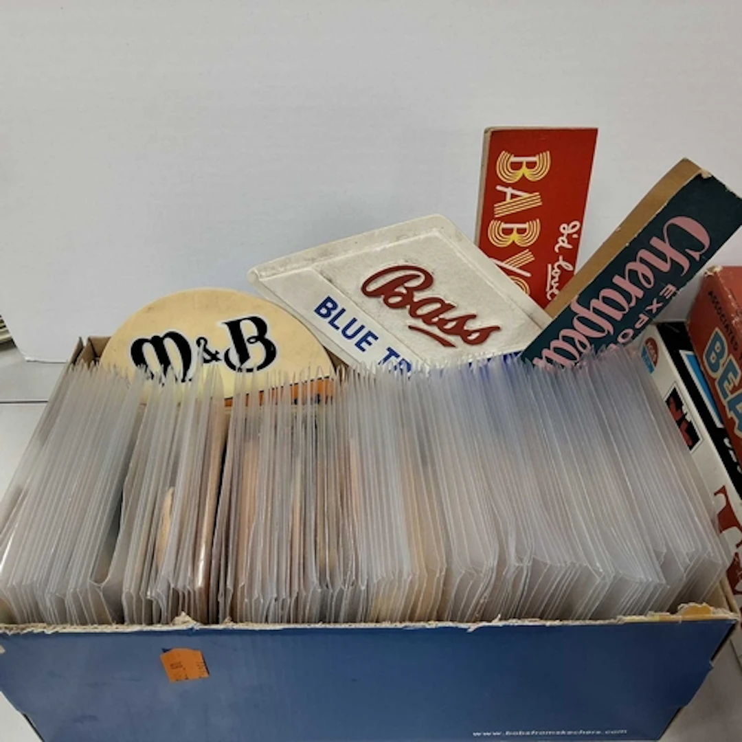 A BOX OF ADVERTISING BEER MATS AND SIGNS, approximately one ...