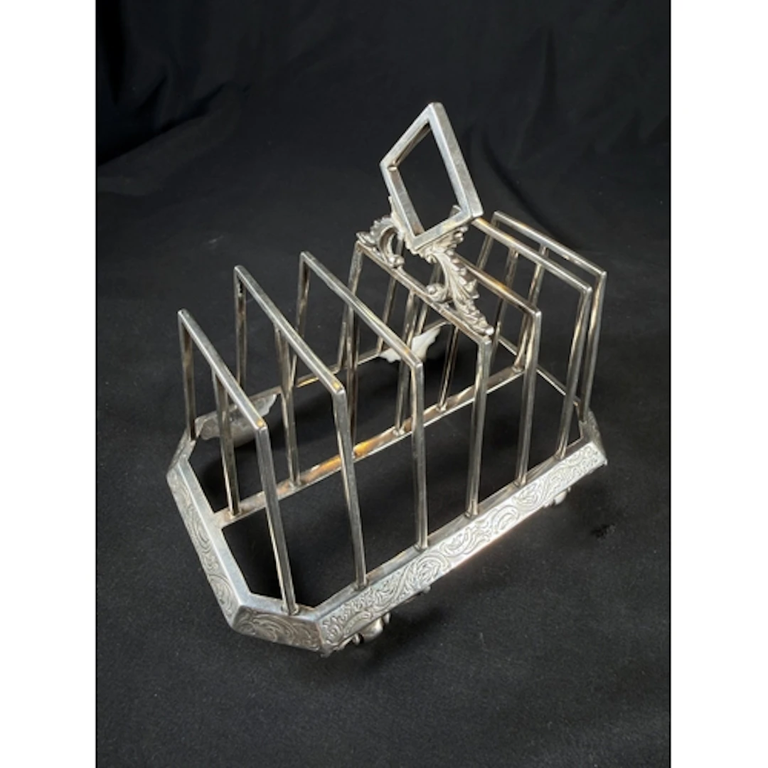 A Victorian hallmarked silver 6 spaced toast rack with etche...