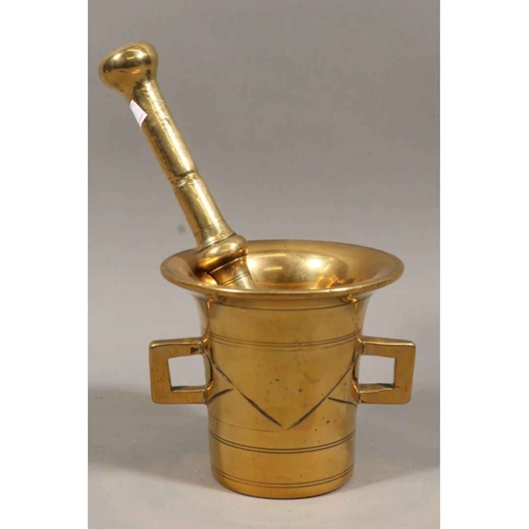 Brass pestle and mortar, indistinctly engraved to handle.