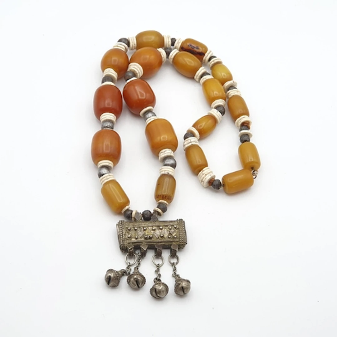 An Amber Type Bead Necklace (Somali?) with white metal cent...