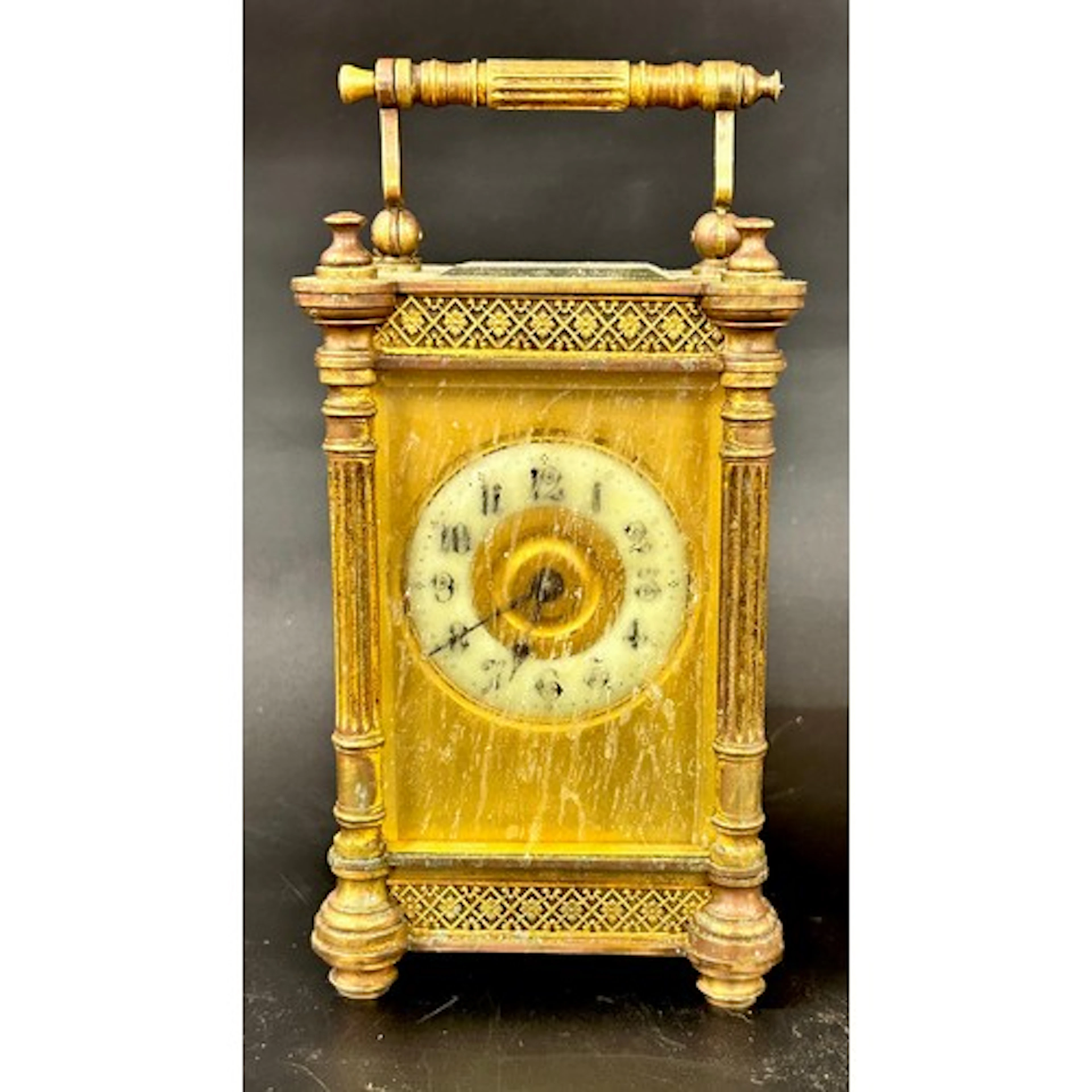A brass carriage clock, with enamel face, decorative borders...