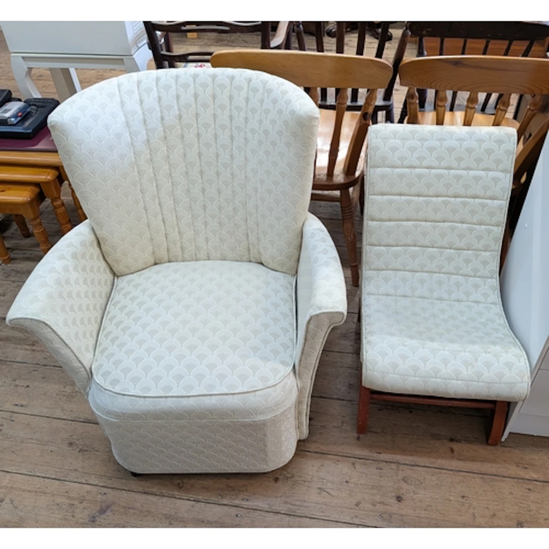 A small cream upholstered bedroom armchair and a matching oc...