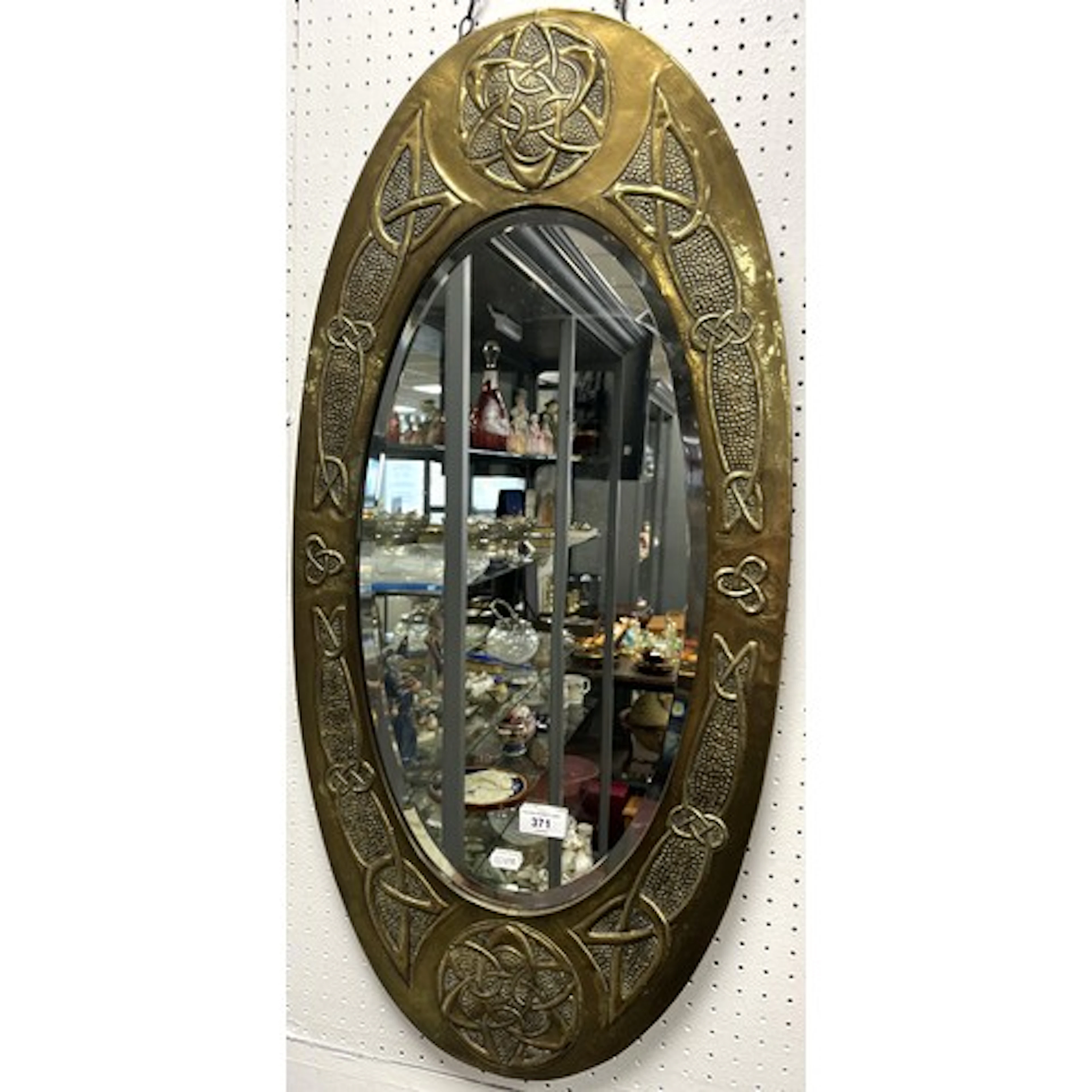 Brass Arts and Craft oval mirror decorated with Celtic knots