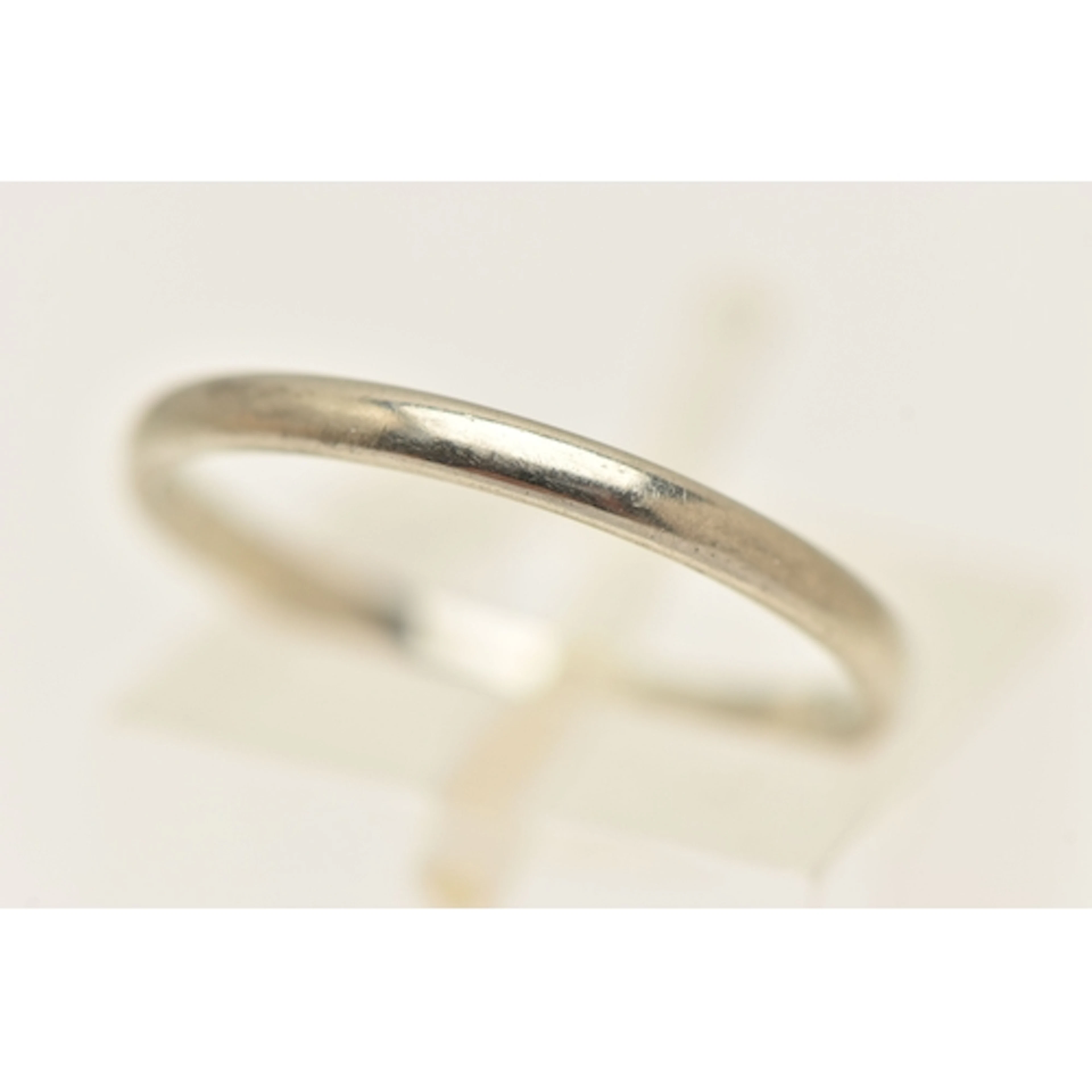 AN 18CT GOLD BAND RING, a plain polished white gold band rin...
