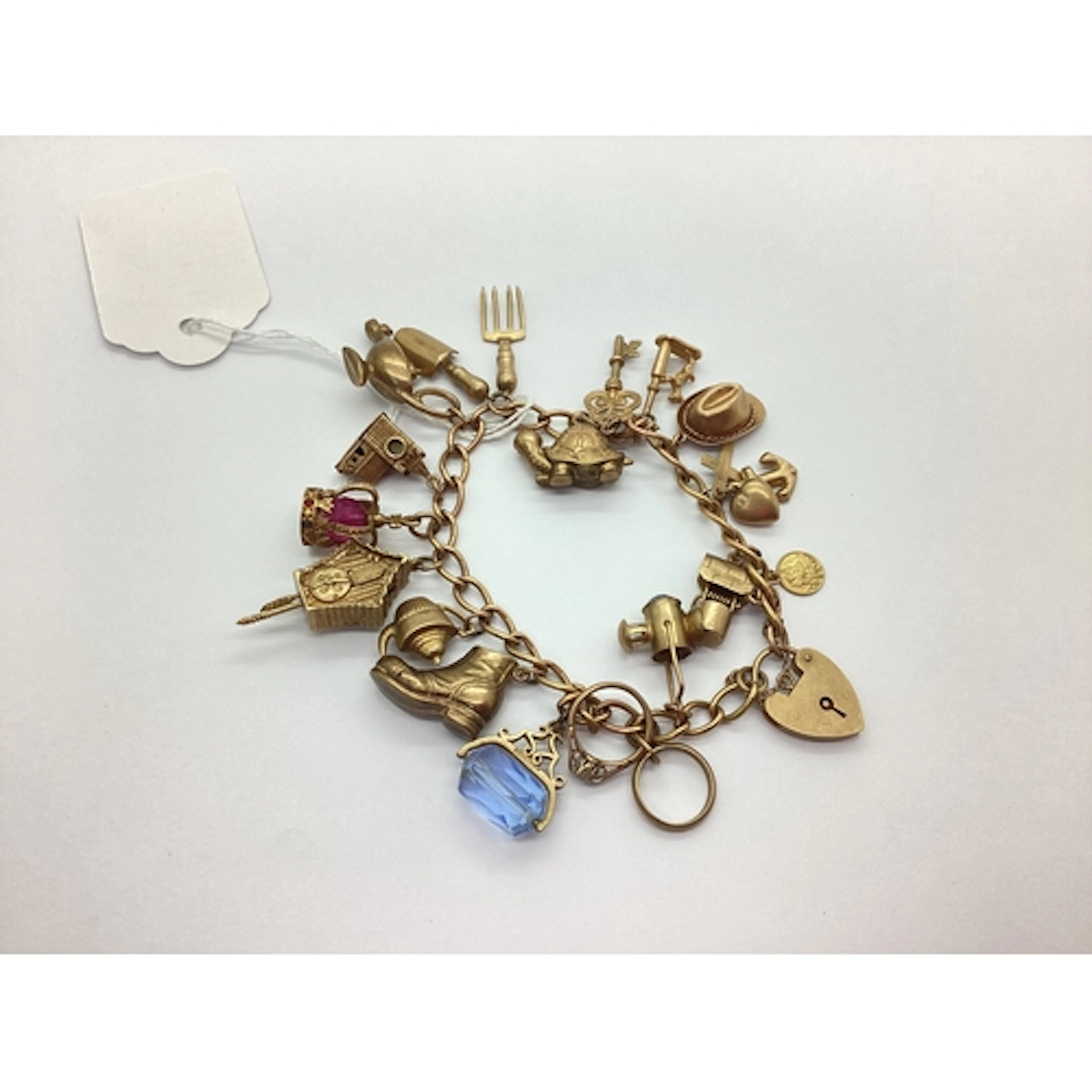 A 9ct Gold Curb Link Bracelet, suspending numerous 9ct gold ...