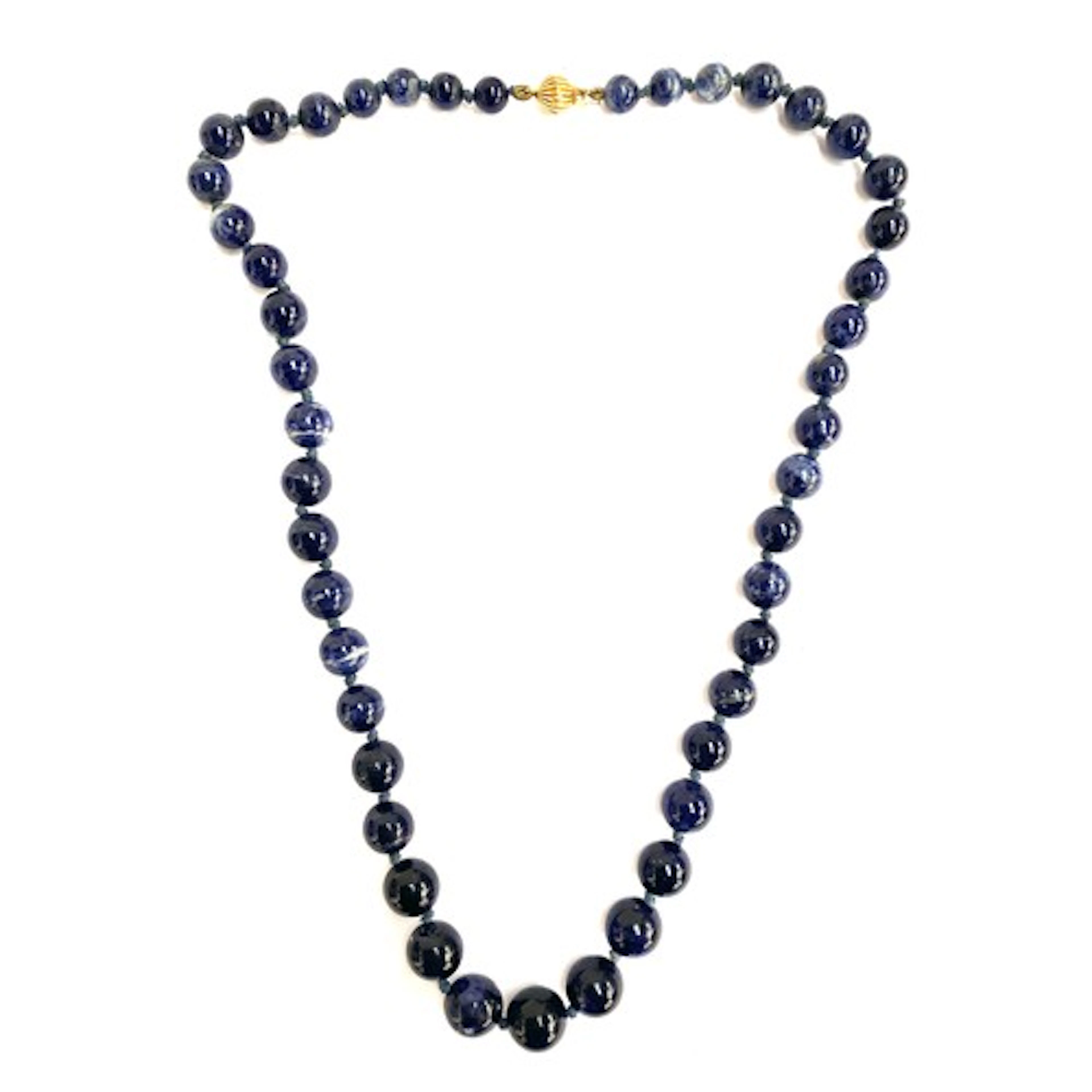 A sodalite bead necklace fastening with a 9ct gold clasp, 54...