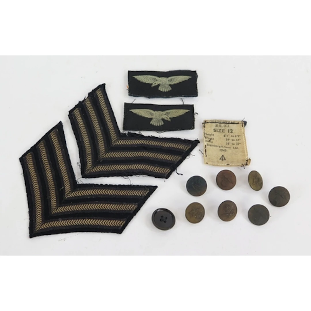 A collection of RAF badges, coat buttons, and sergeant's str...