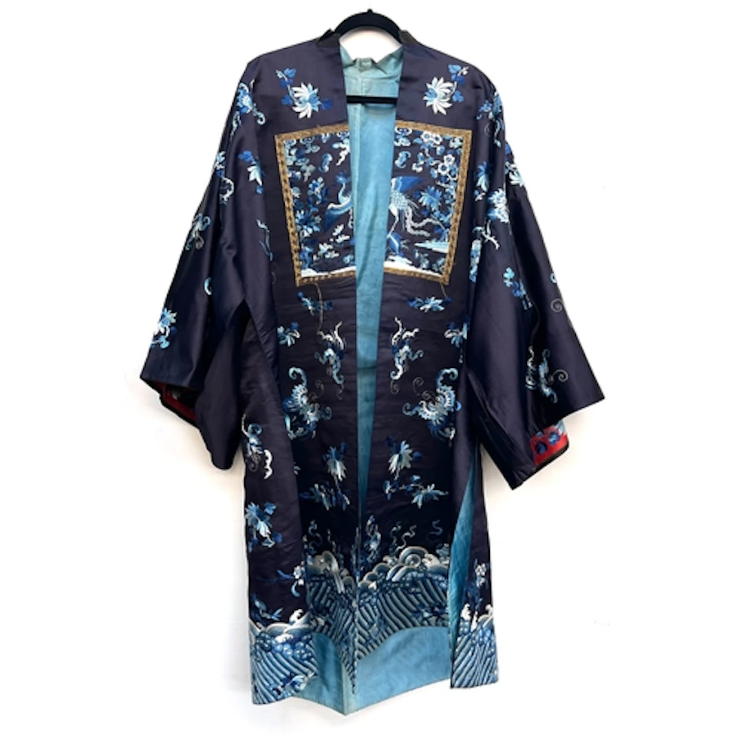 An antique Chinese navy blue silk robe, with striped blue an...