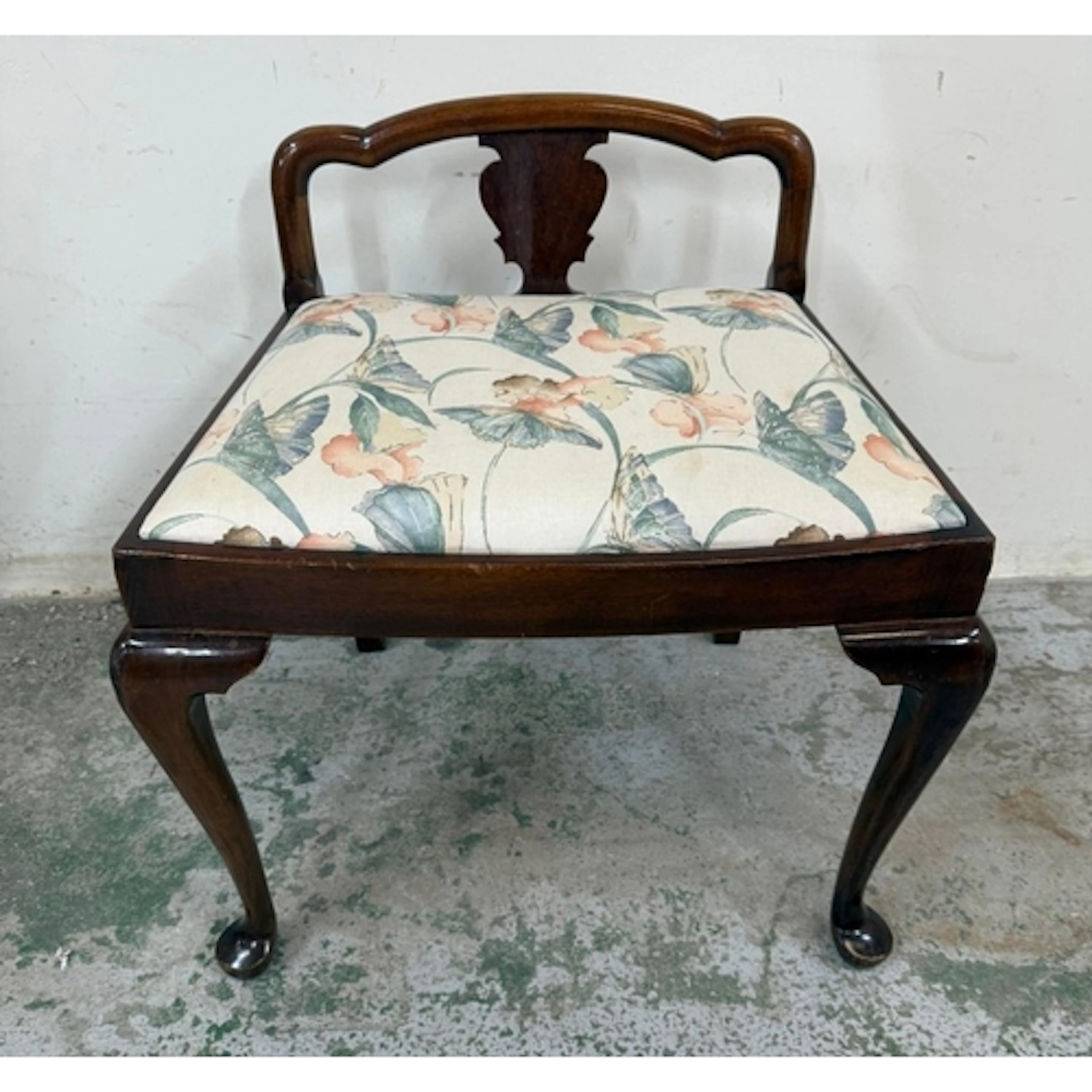A mahogany music stool on cabriole legs