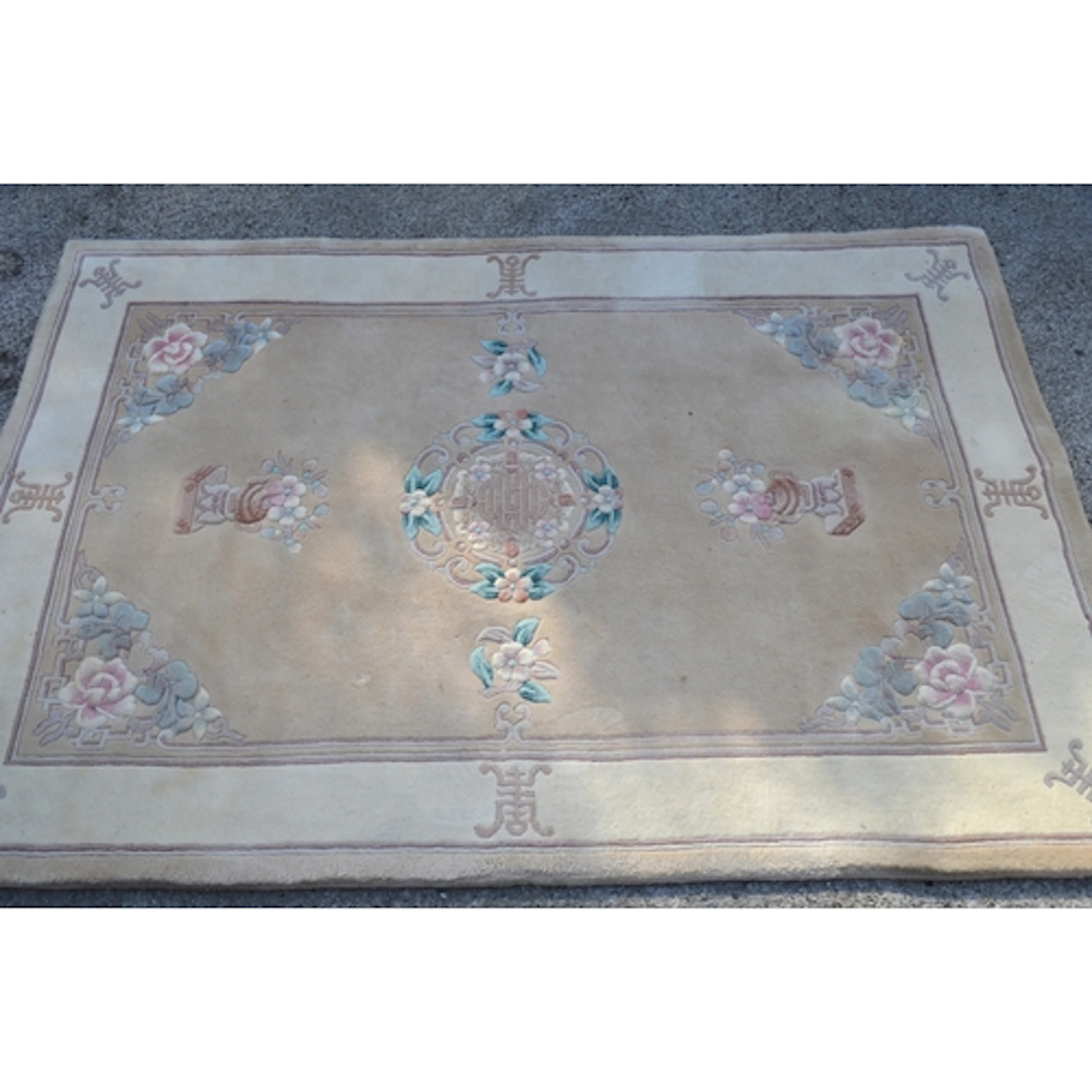 Chinese rug with medallion and vase design on a beige ground...